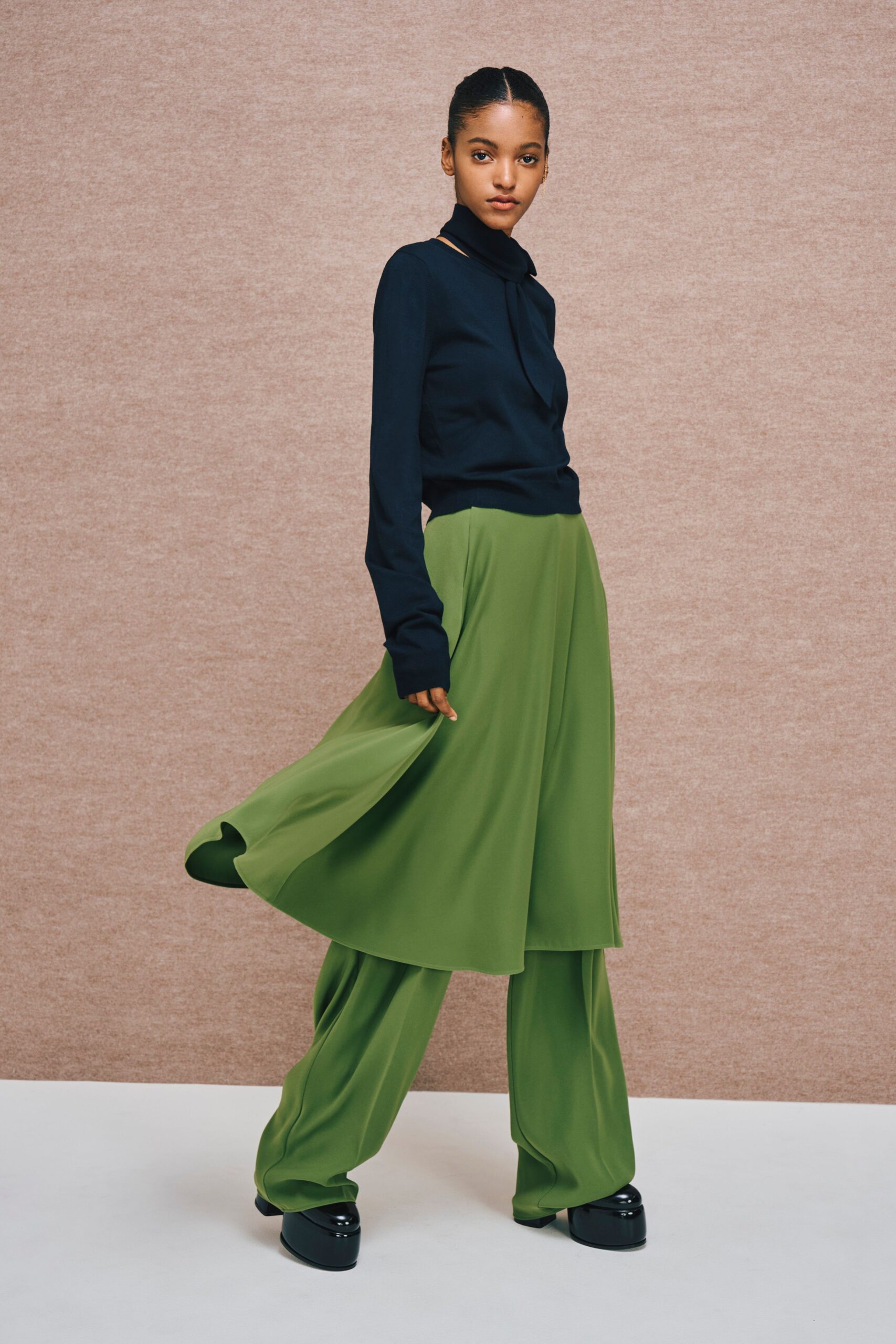 black shirt green wide-leg pants