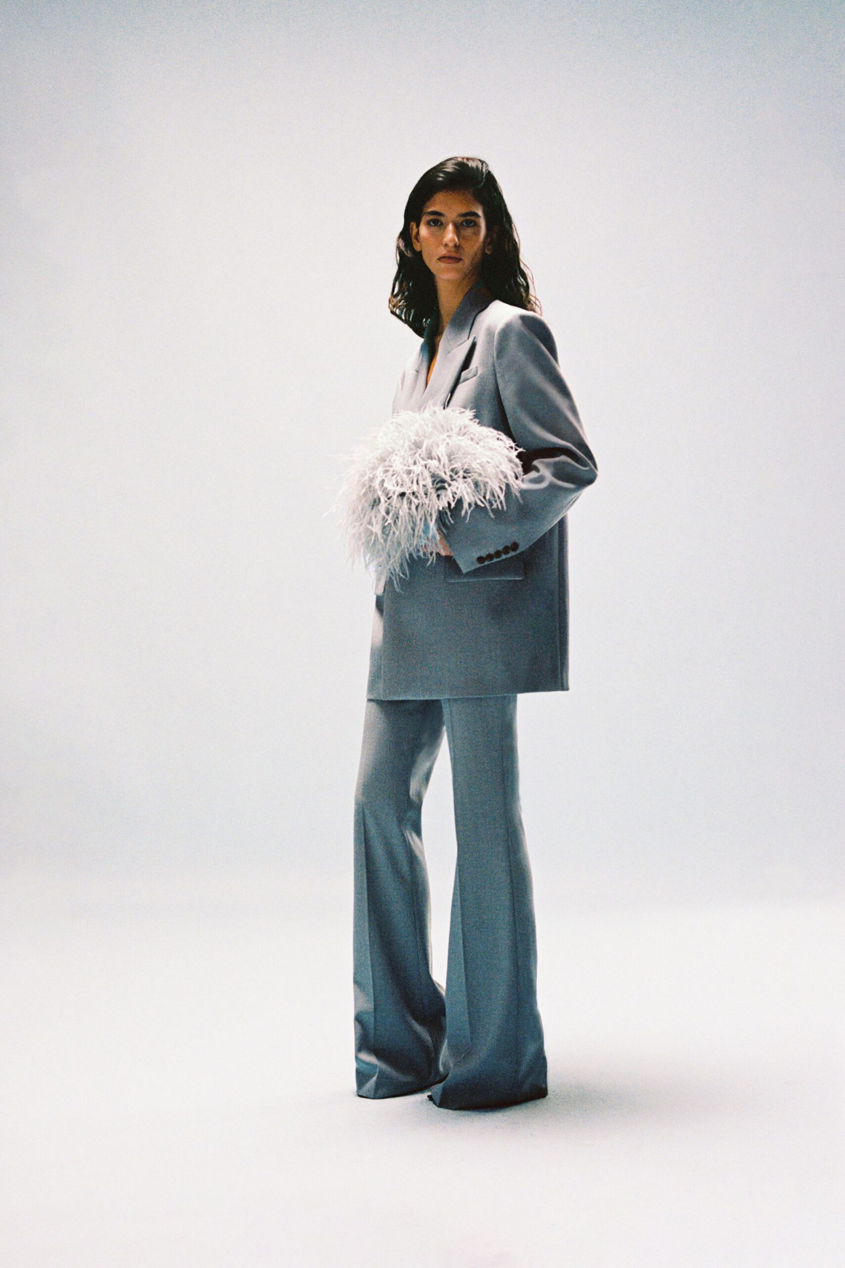 blue gray blazer with feather clutch
