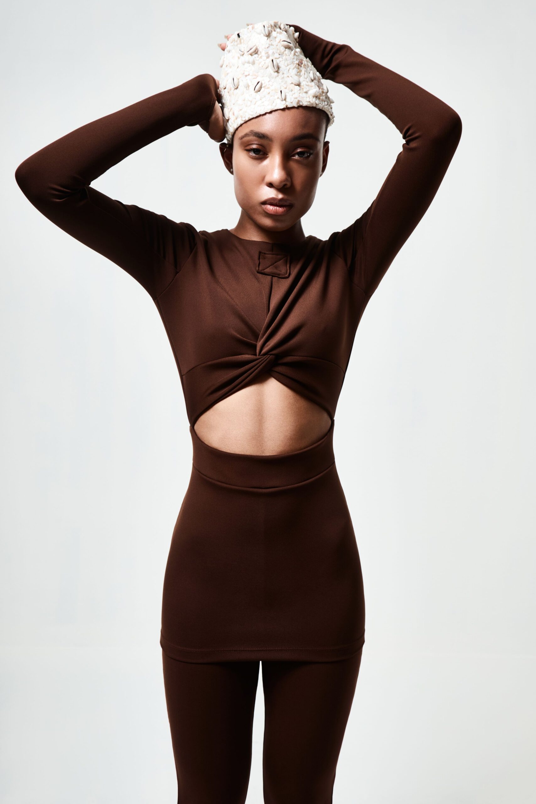 brown fitted top and leggings with embellished hat