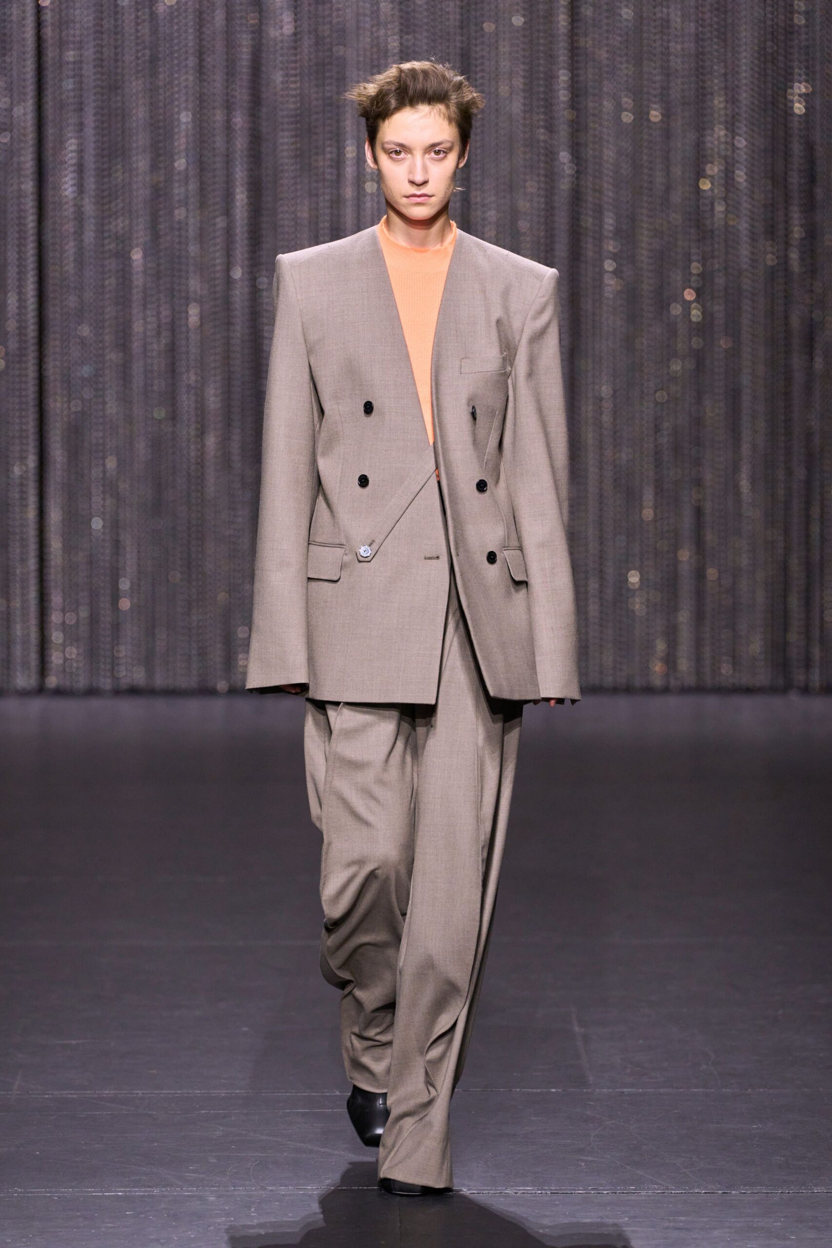 beige tailored suit with orange top