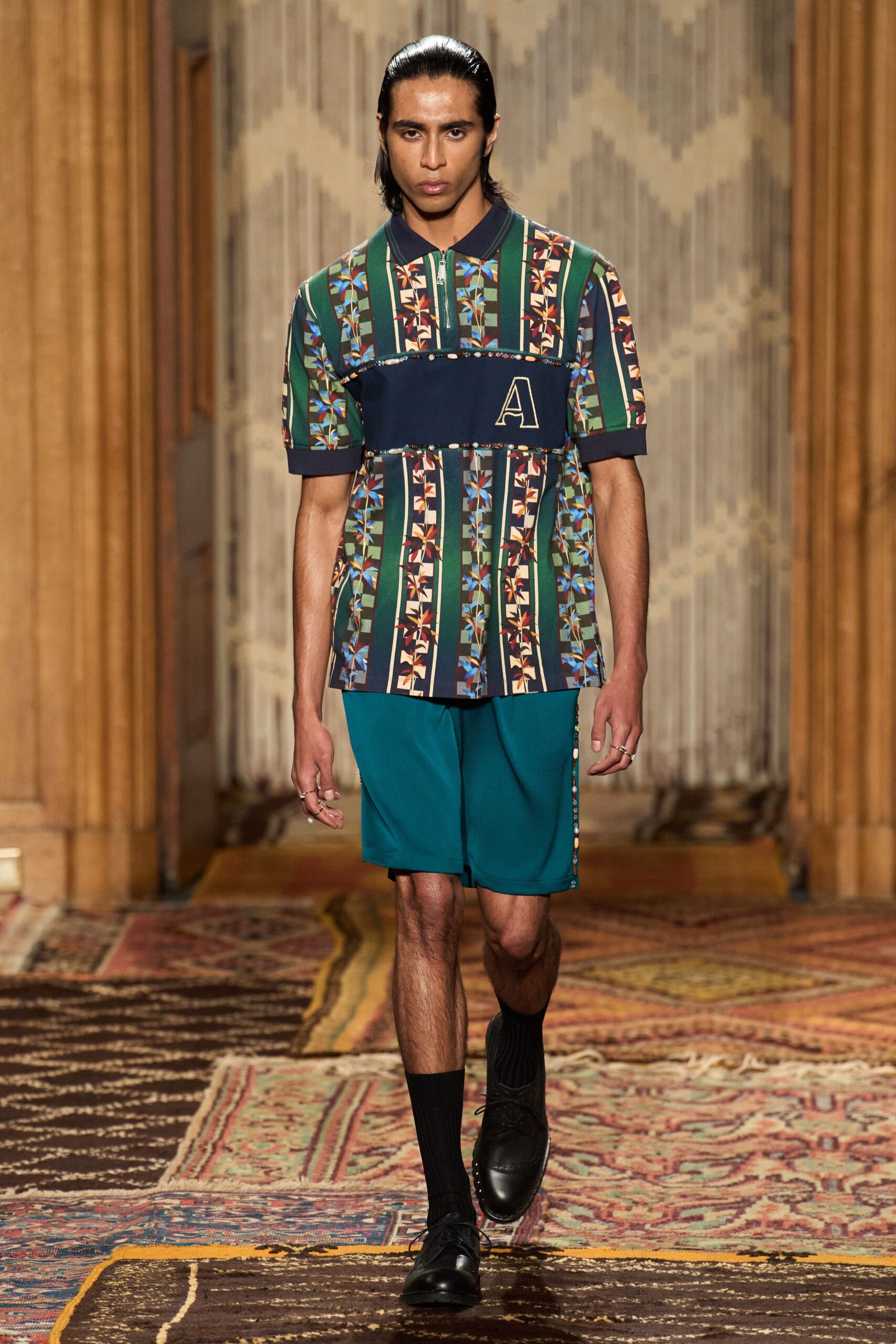 printed shirt and teal shorts
