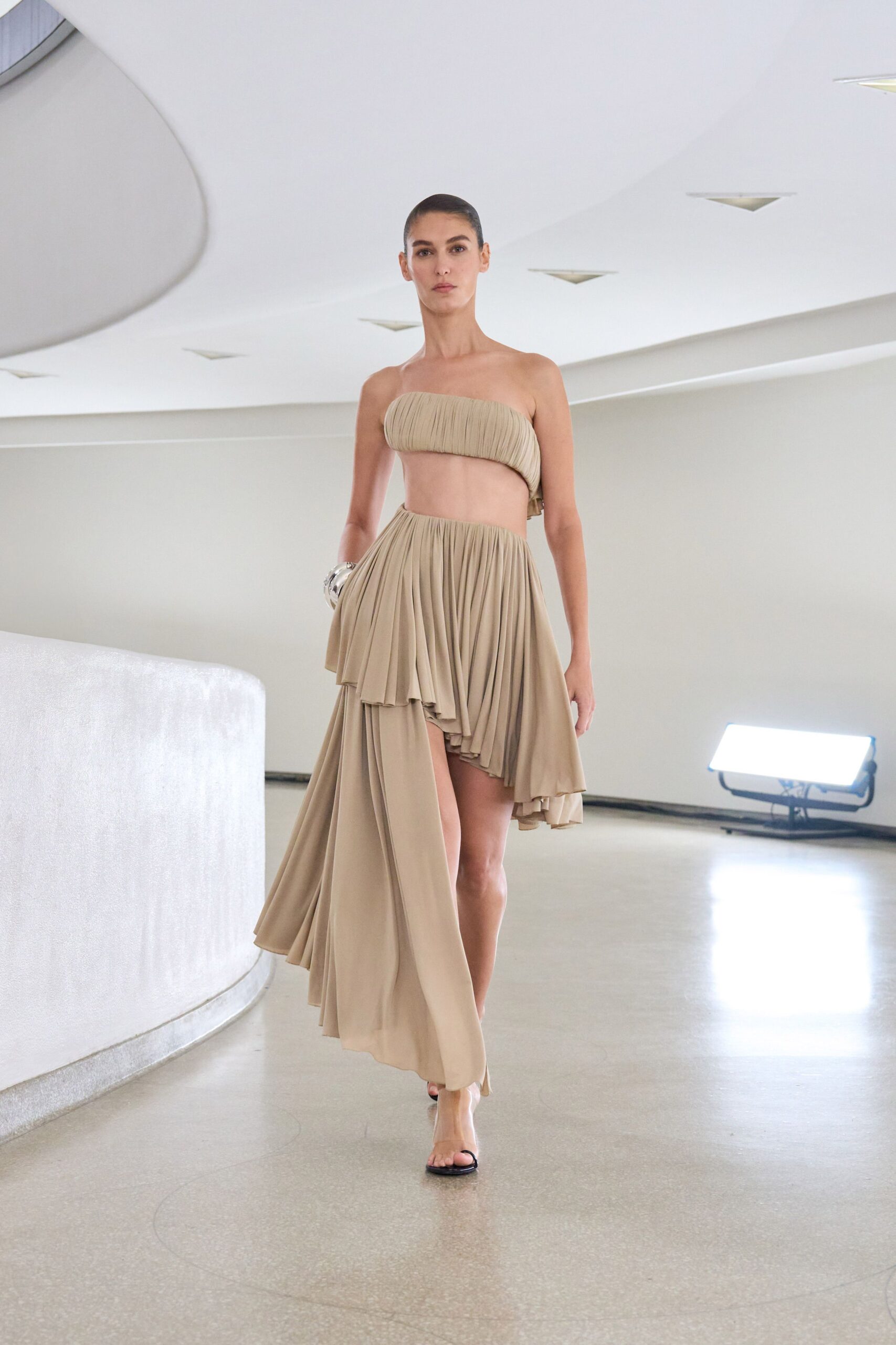 beige silk sleeveless high-neck fitted pleated flowing dress