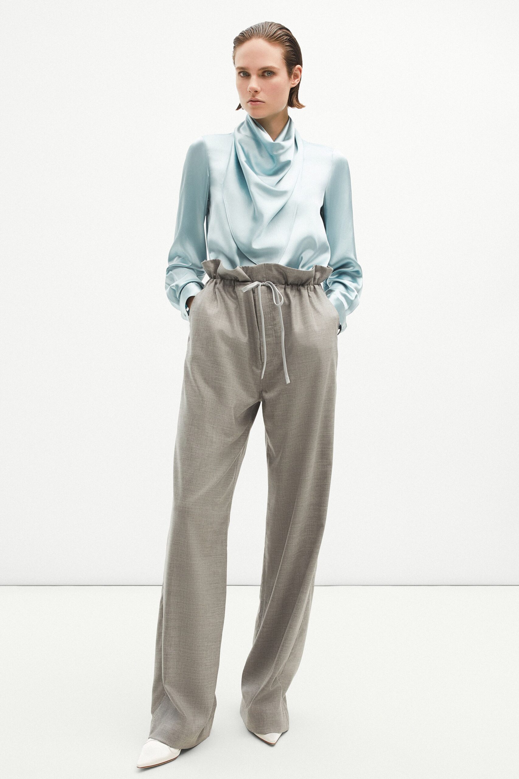 blue silk relaxed top with gray pants