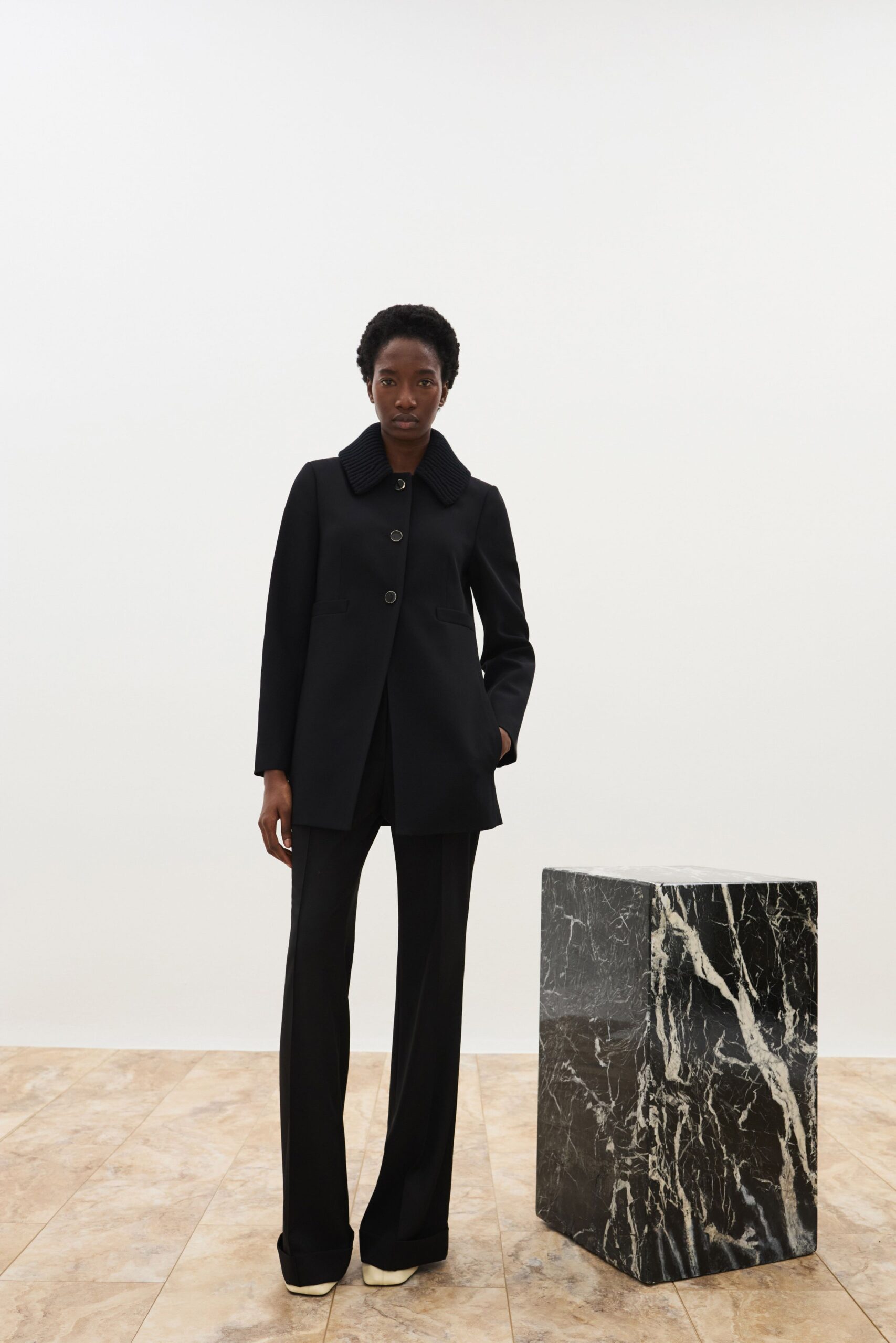 black wool coat with fitted pants