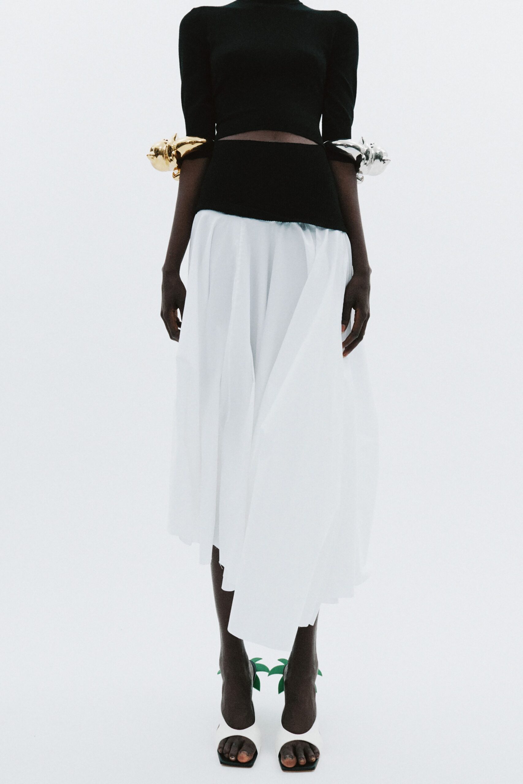 black fitted top white pleated skirt