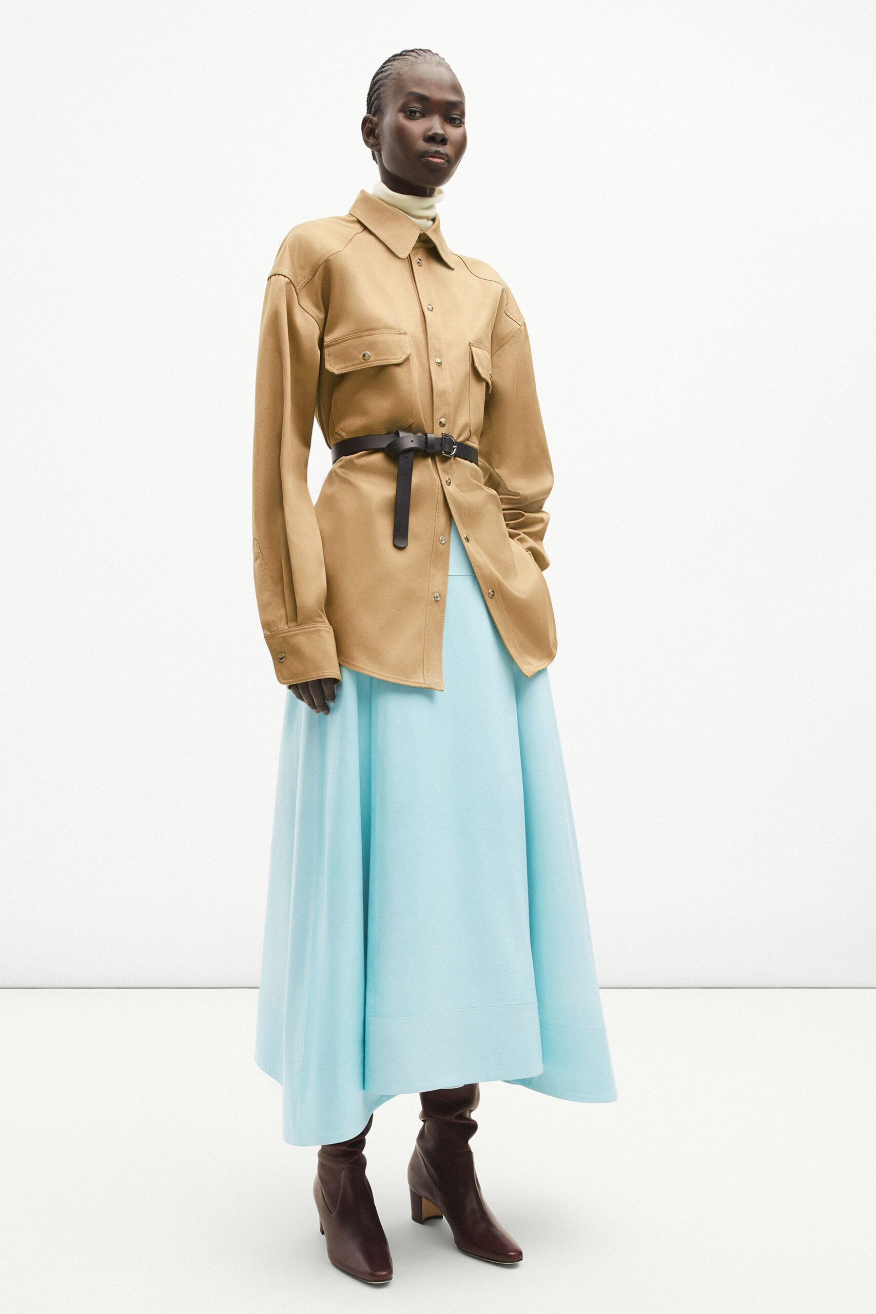 brown leather shirt with blue skirt