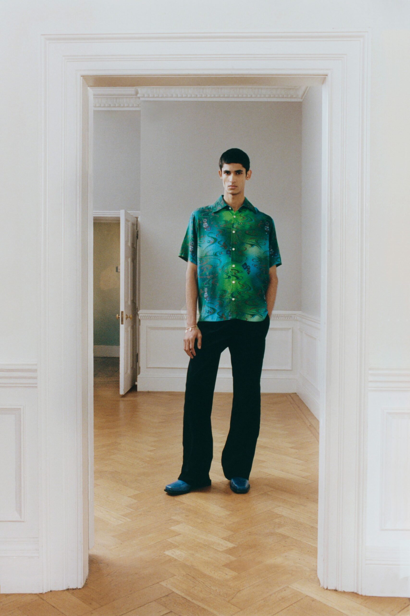 printed green blue shirt with black pants