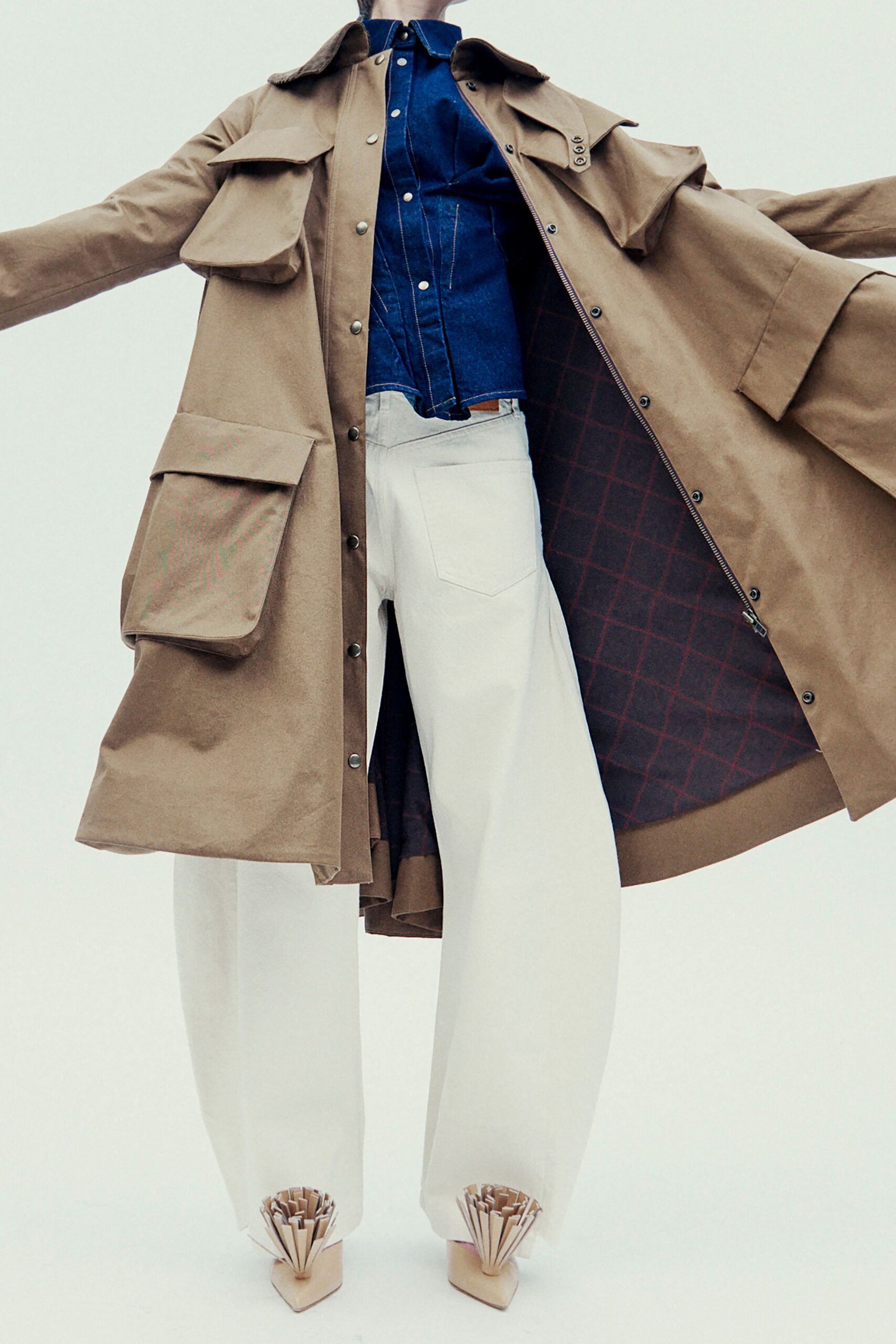 beige coat blue shirt white pants