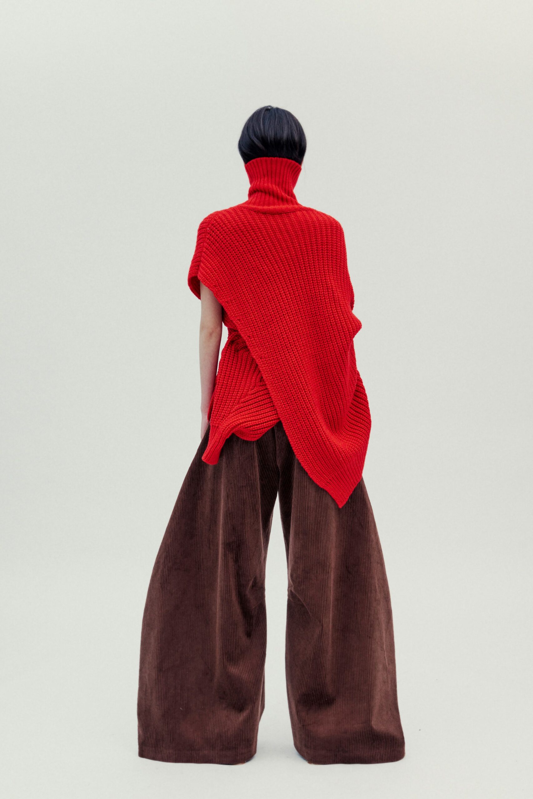 red wool top and brown wide-leg pants