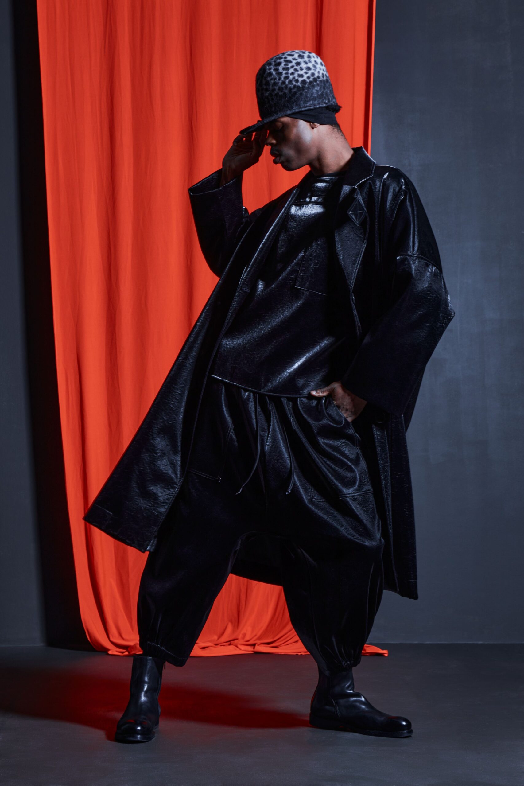 black leather coat with animal-print hat