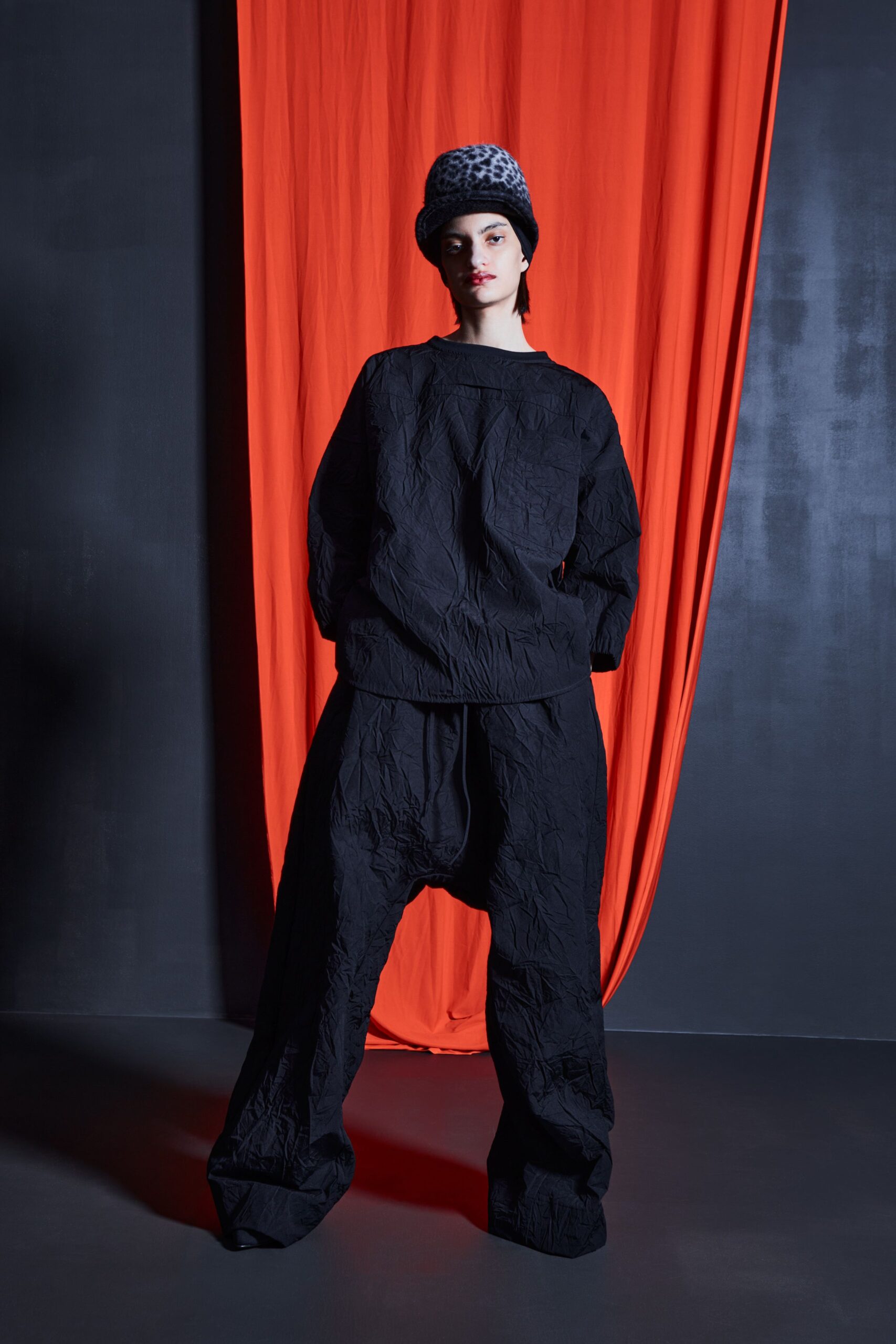 black relaxed top and pants with gray hat