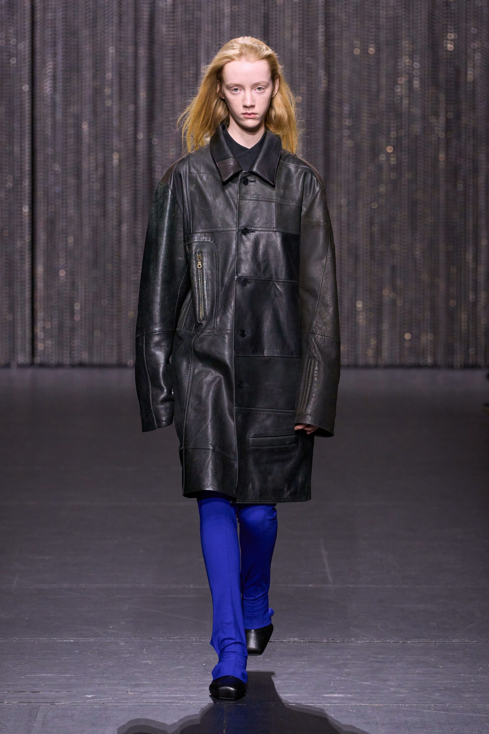 black leather oversized coat with blue pants