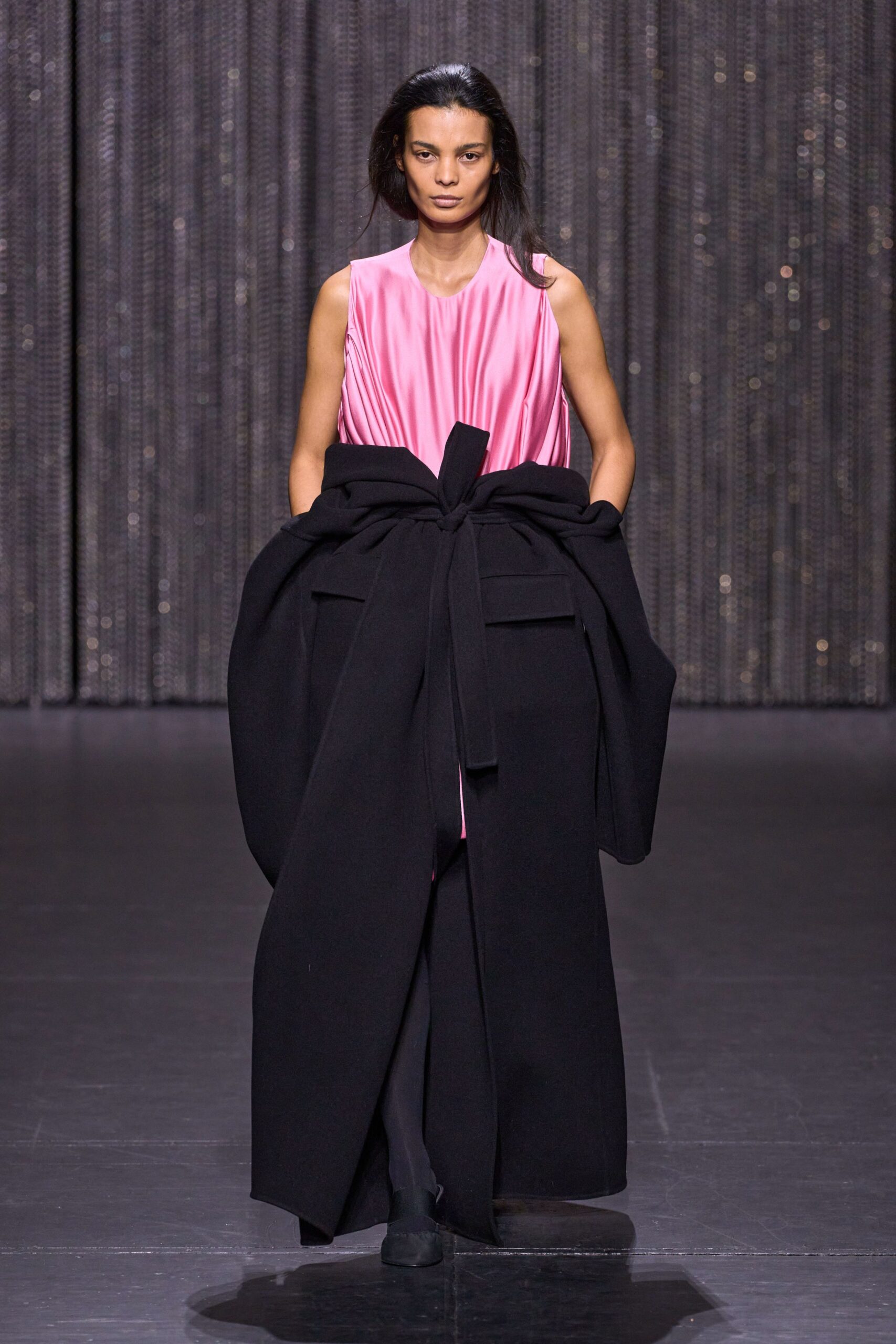 pink pleated midi dress with black coat