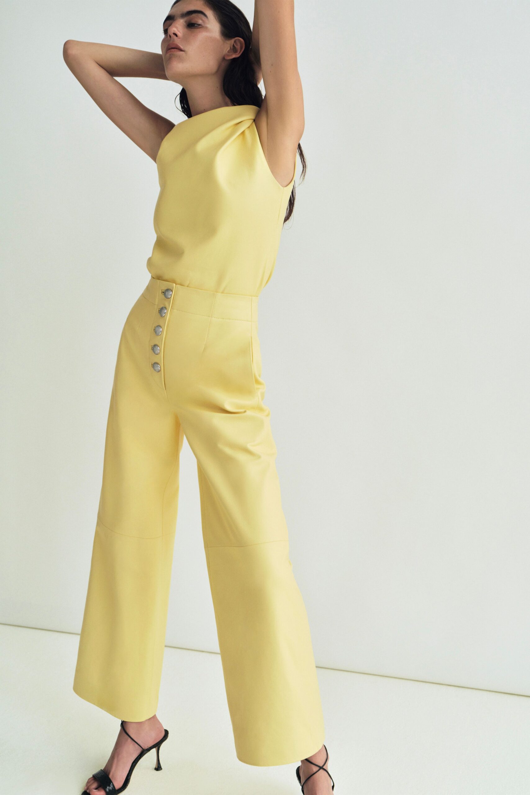 yellow cotton sleeveless high-neck fitted buttoned wide-leg jumpsuit