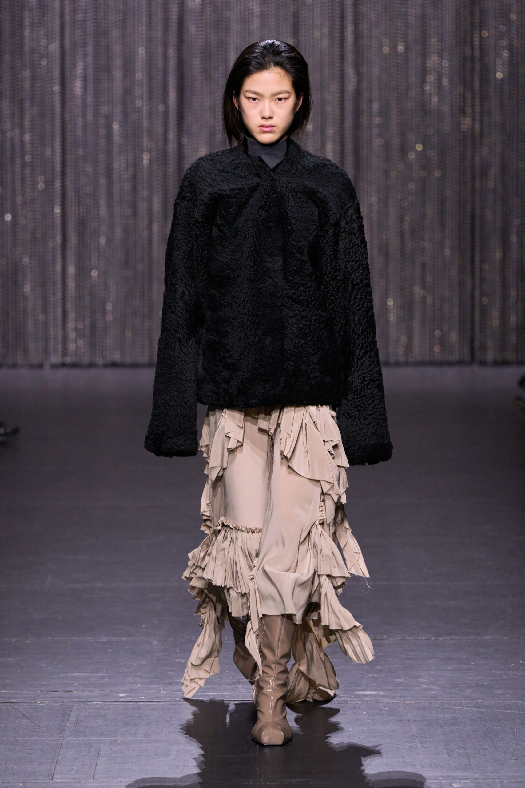 black faux-fur top with beige ruffled skirt