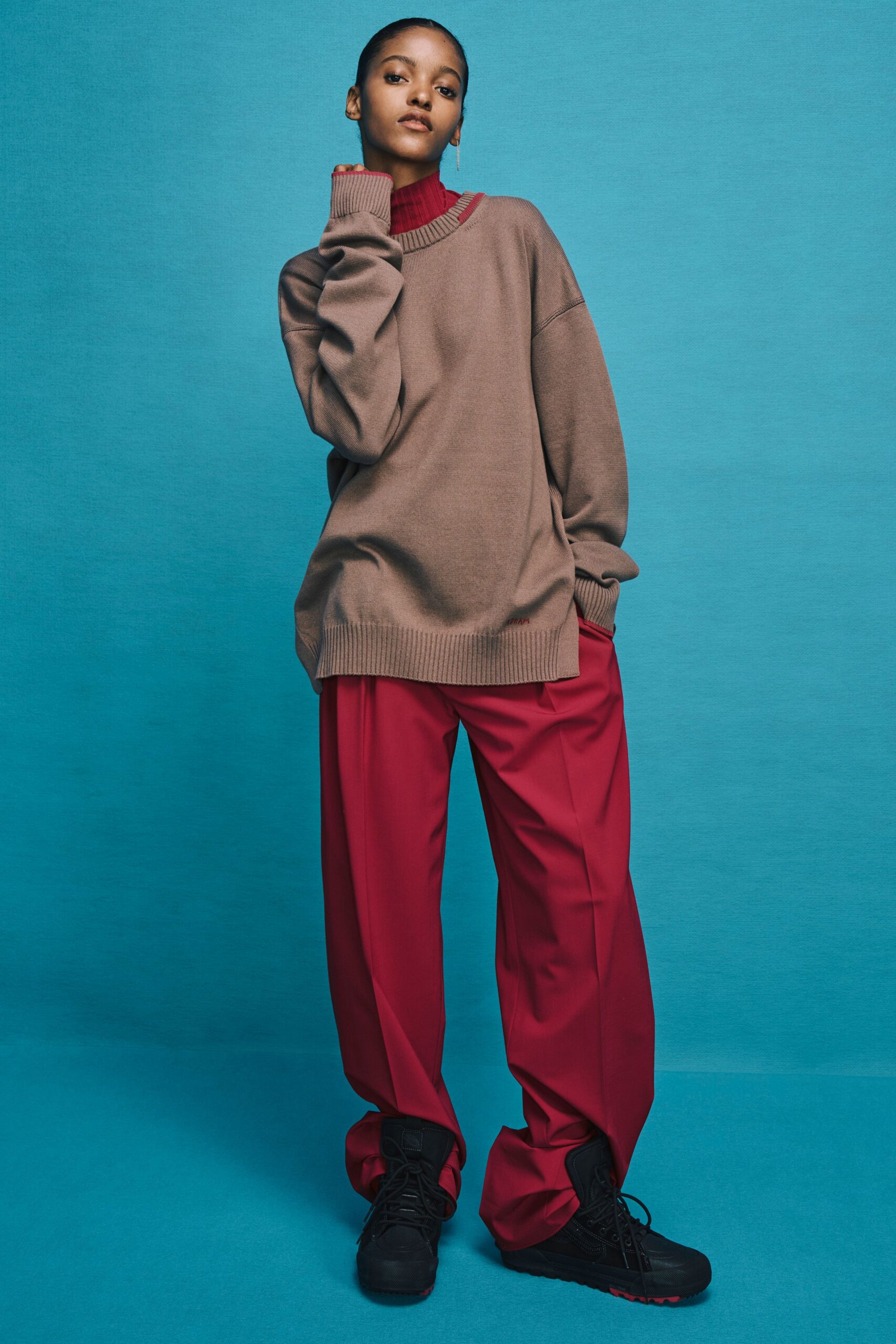 oversized brown sweater with relaxed red pants