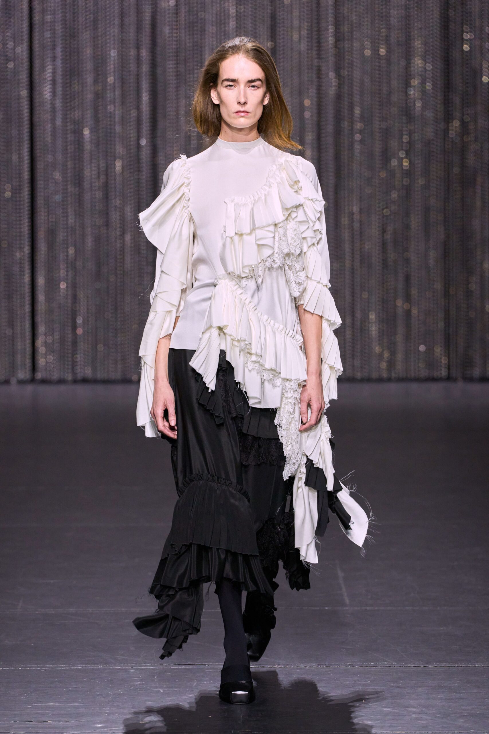 white ruffled top and black tiered skirt