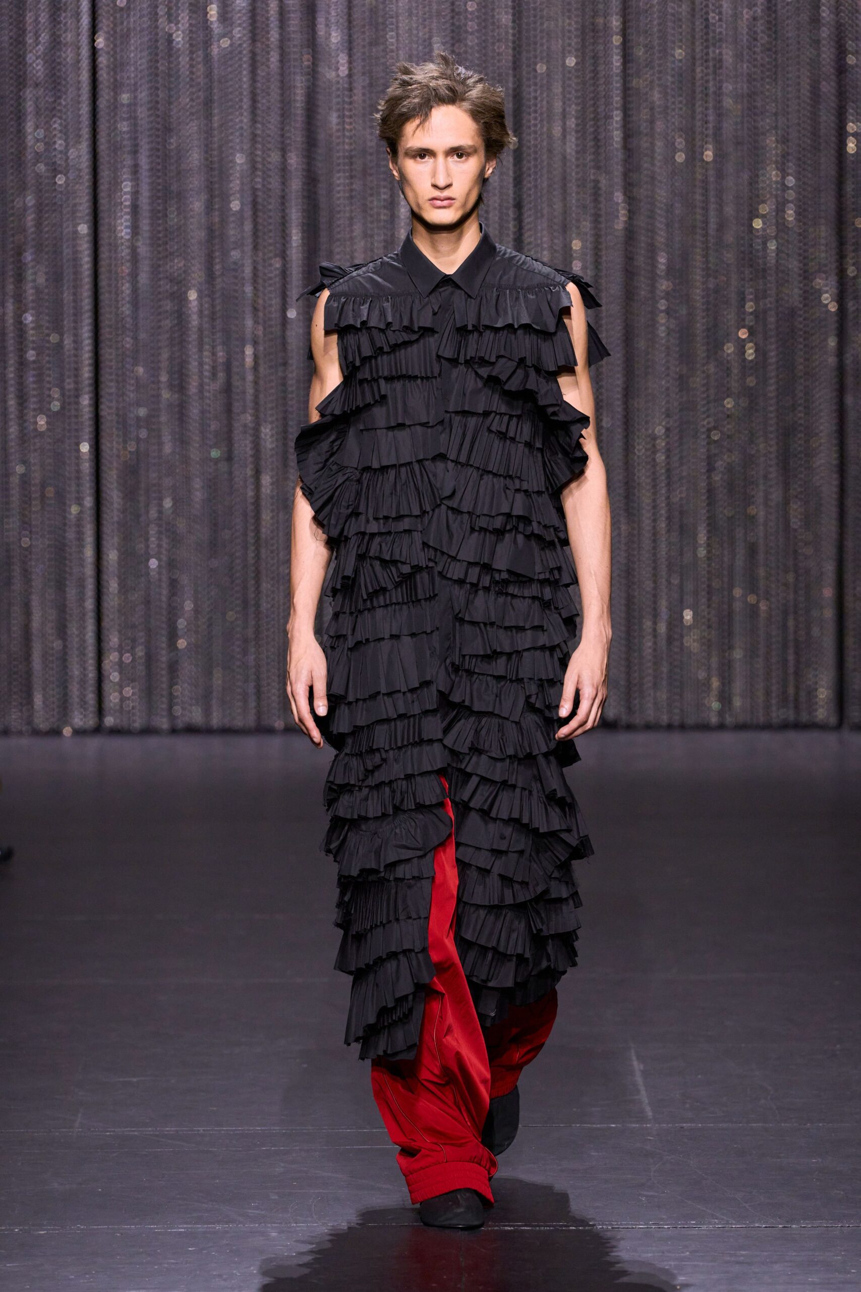 black pleated maxi dress and red pants