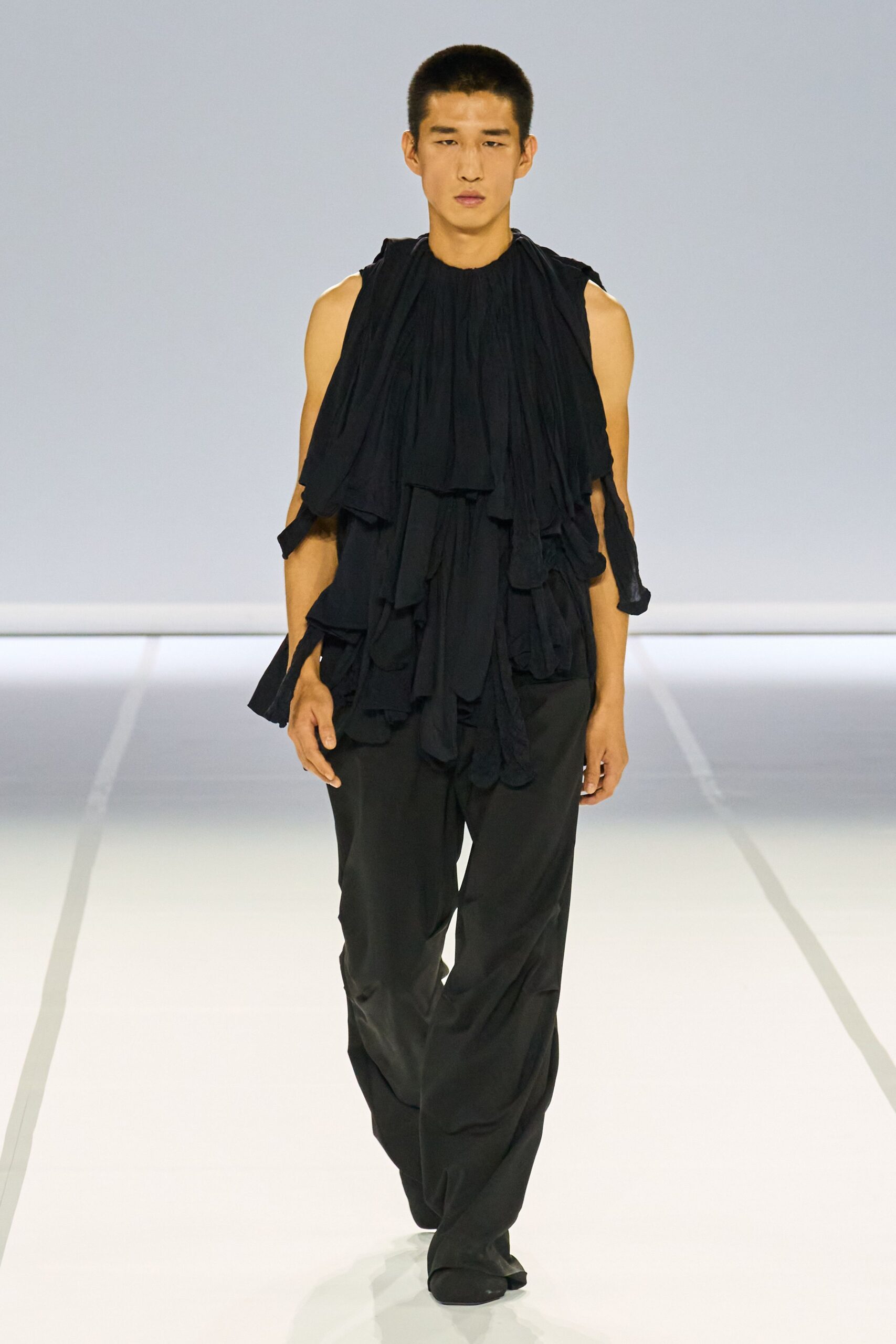 black ruffled top with relaxed pants