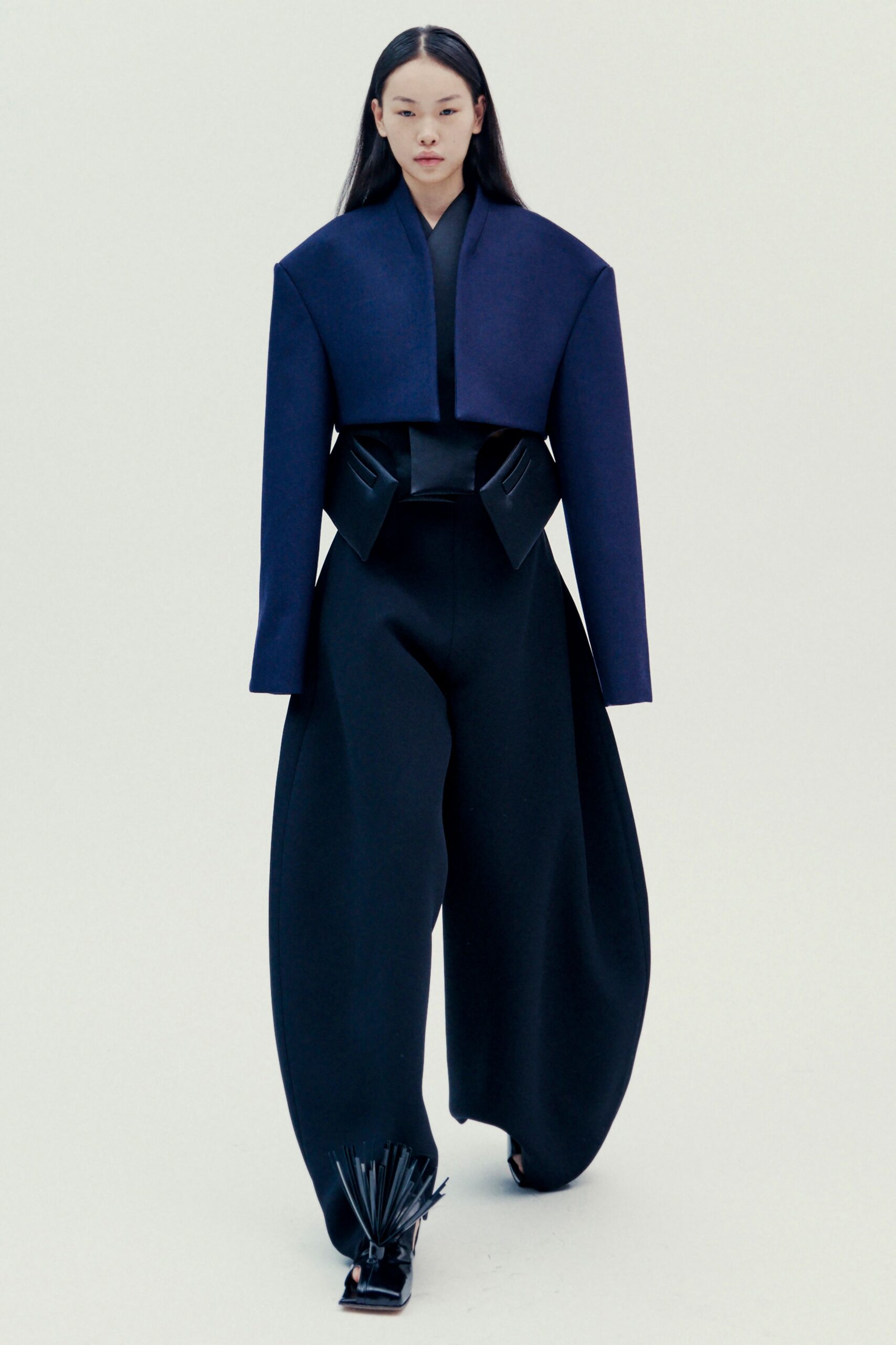 blue structured jacket with black top and pants