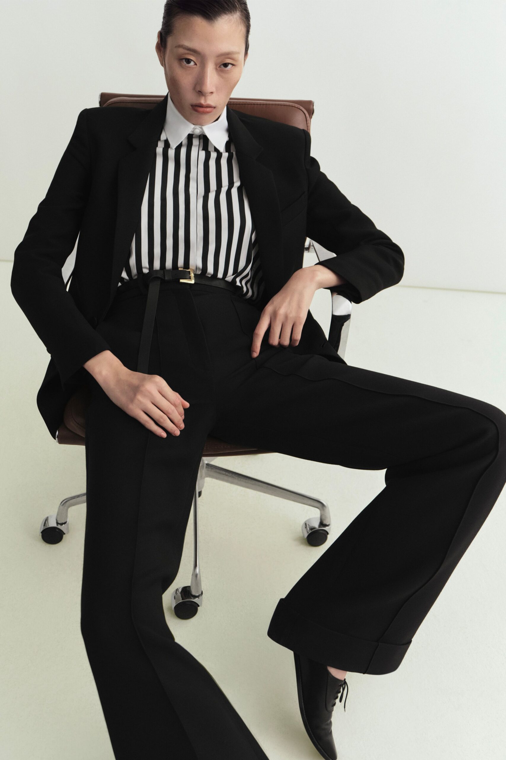 black tailored suit with striped shirt