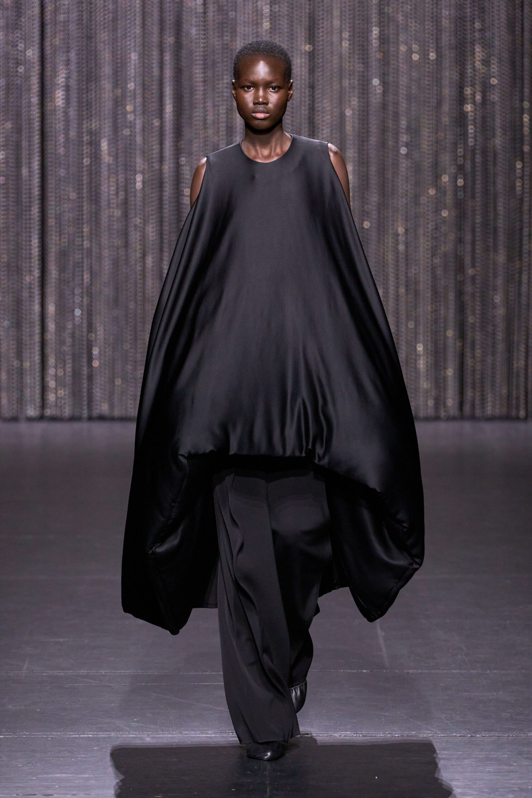 black draped maxi dress with fitted pants