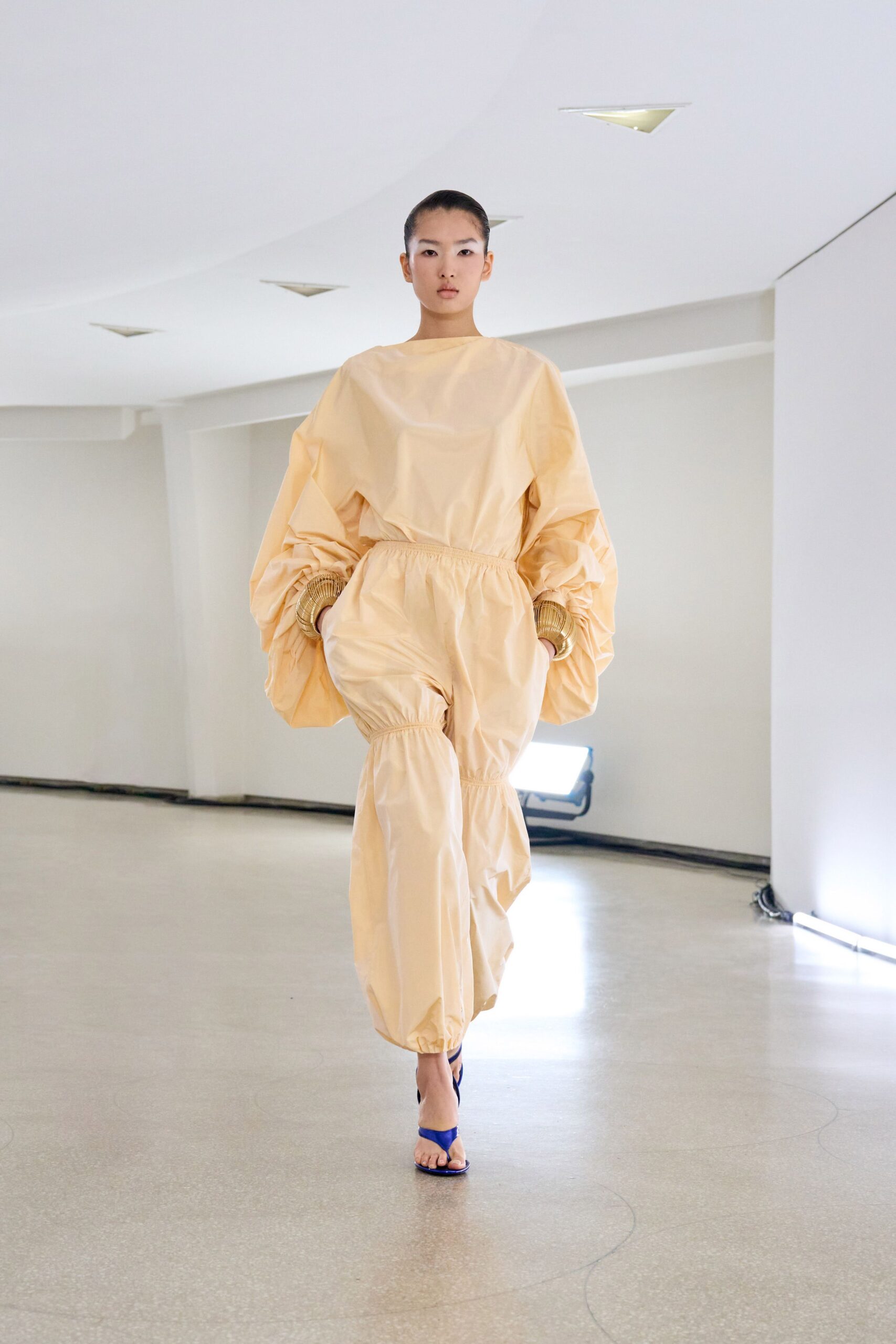 beige cotton long-sleeve relaxed pleated jumpsuit