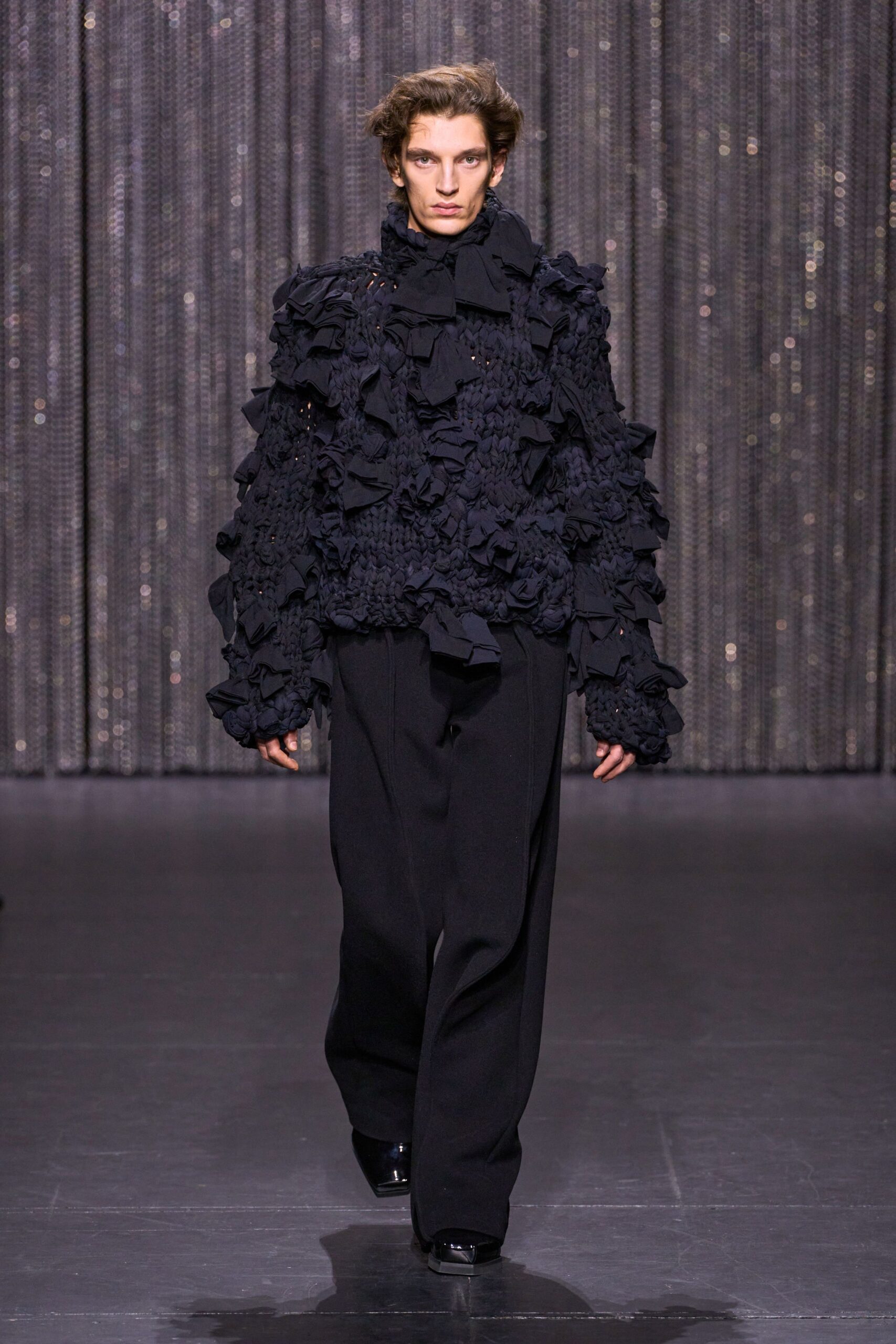 black ruffled top with relaxed pants