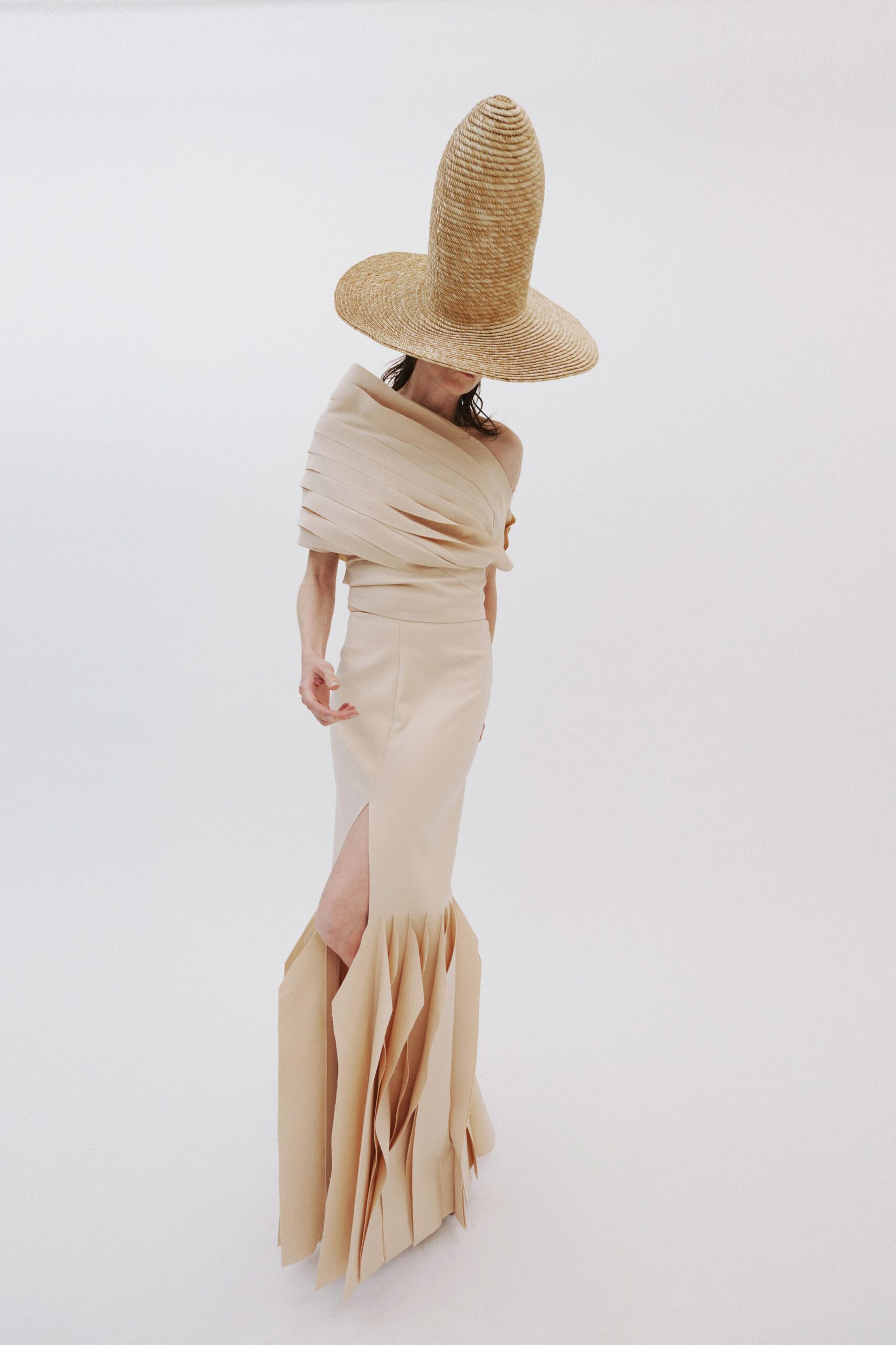 beige silk sleeveless off-shoulder fitted pleated maxi gown