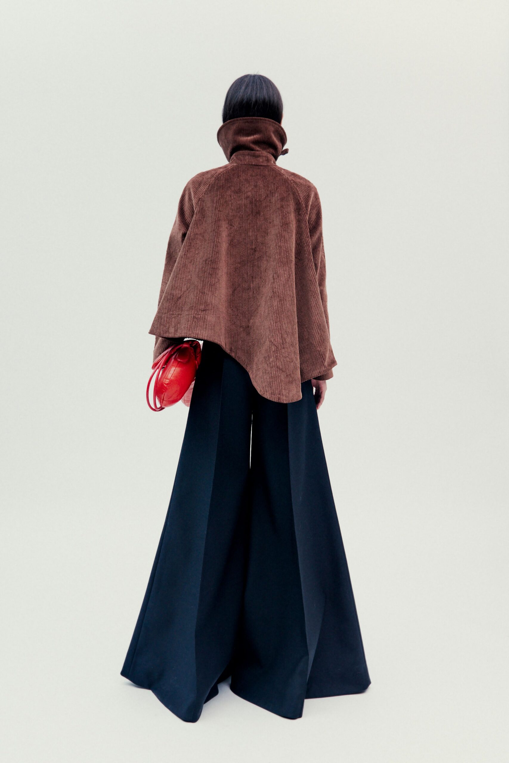 brown cape black wide-leg pants