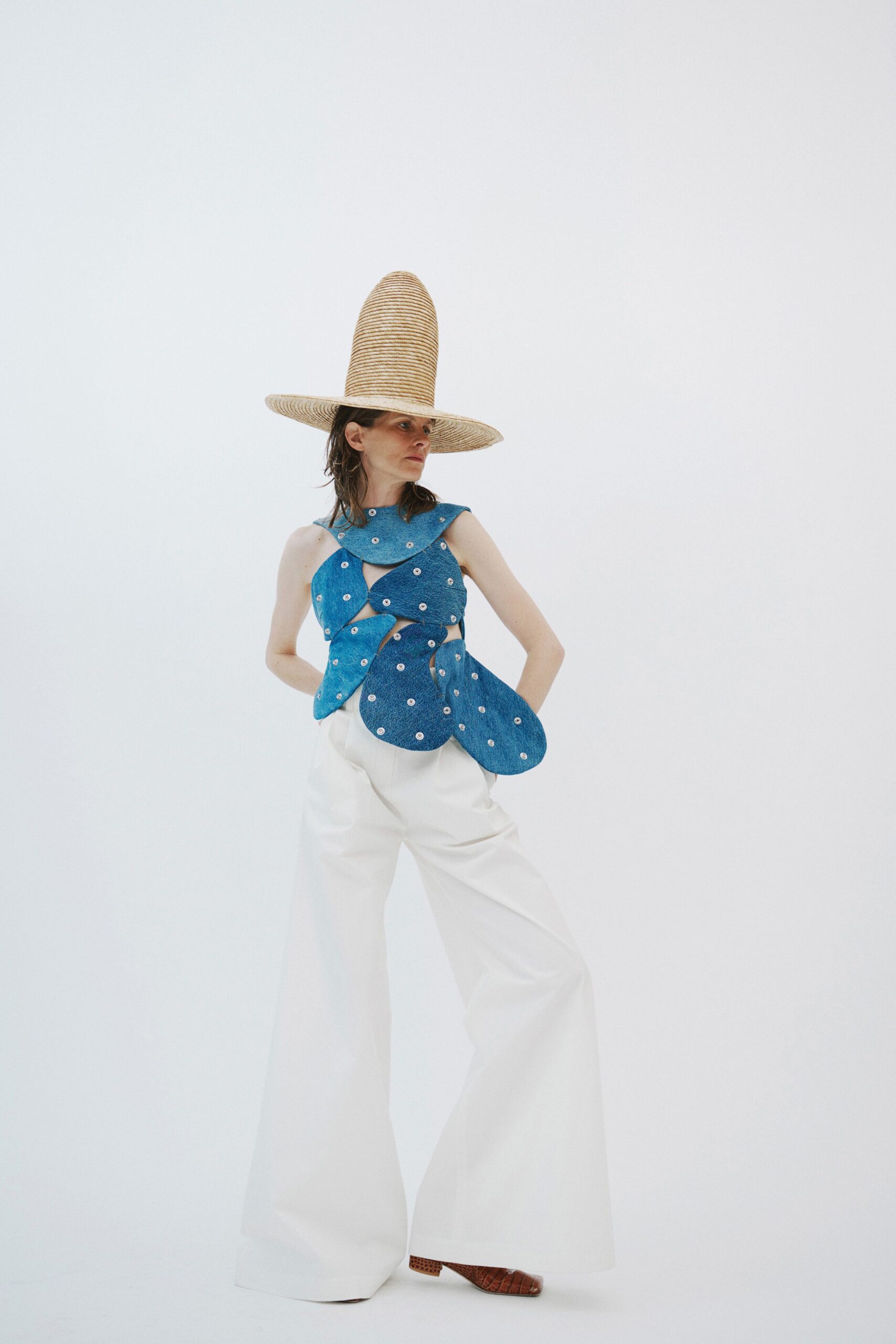 blue polka-dot top with white pants