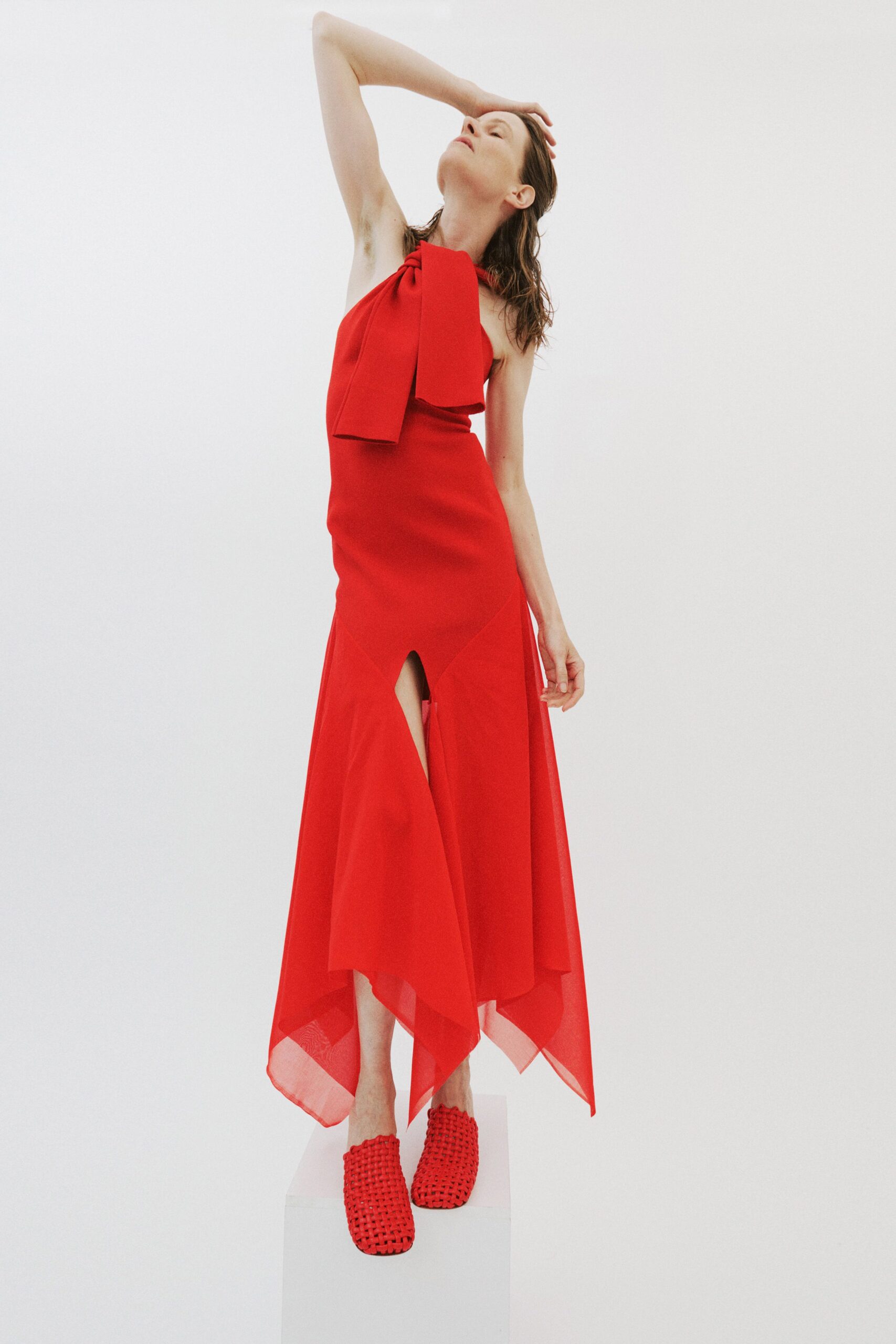 red silk sleeveless high-neck fitted flowing midi dress