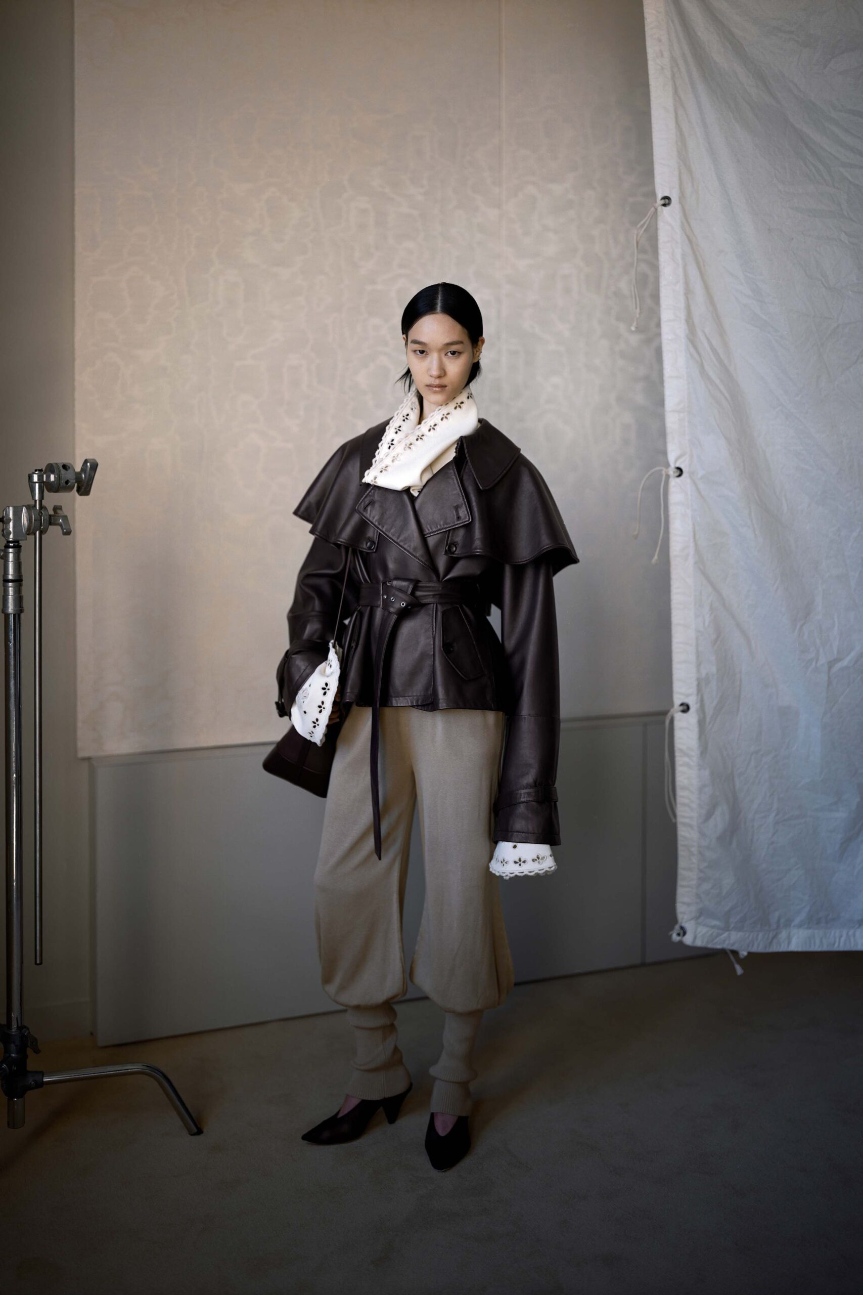 brown leather jacket with white blouse