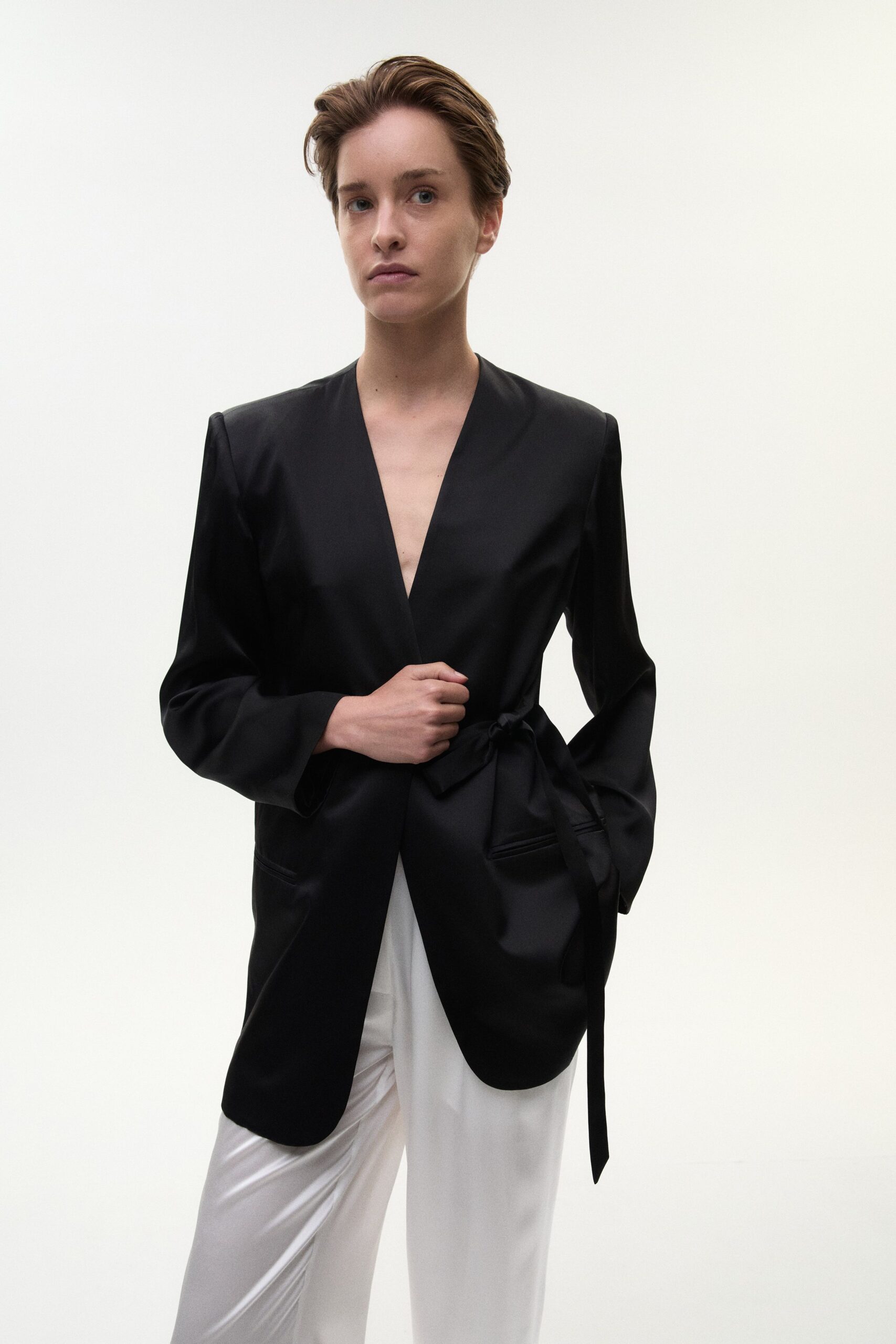 black satin tailored blazer and white pants