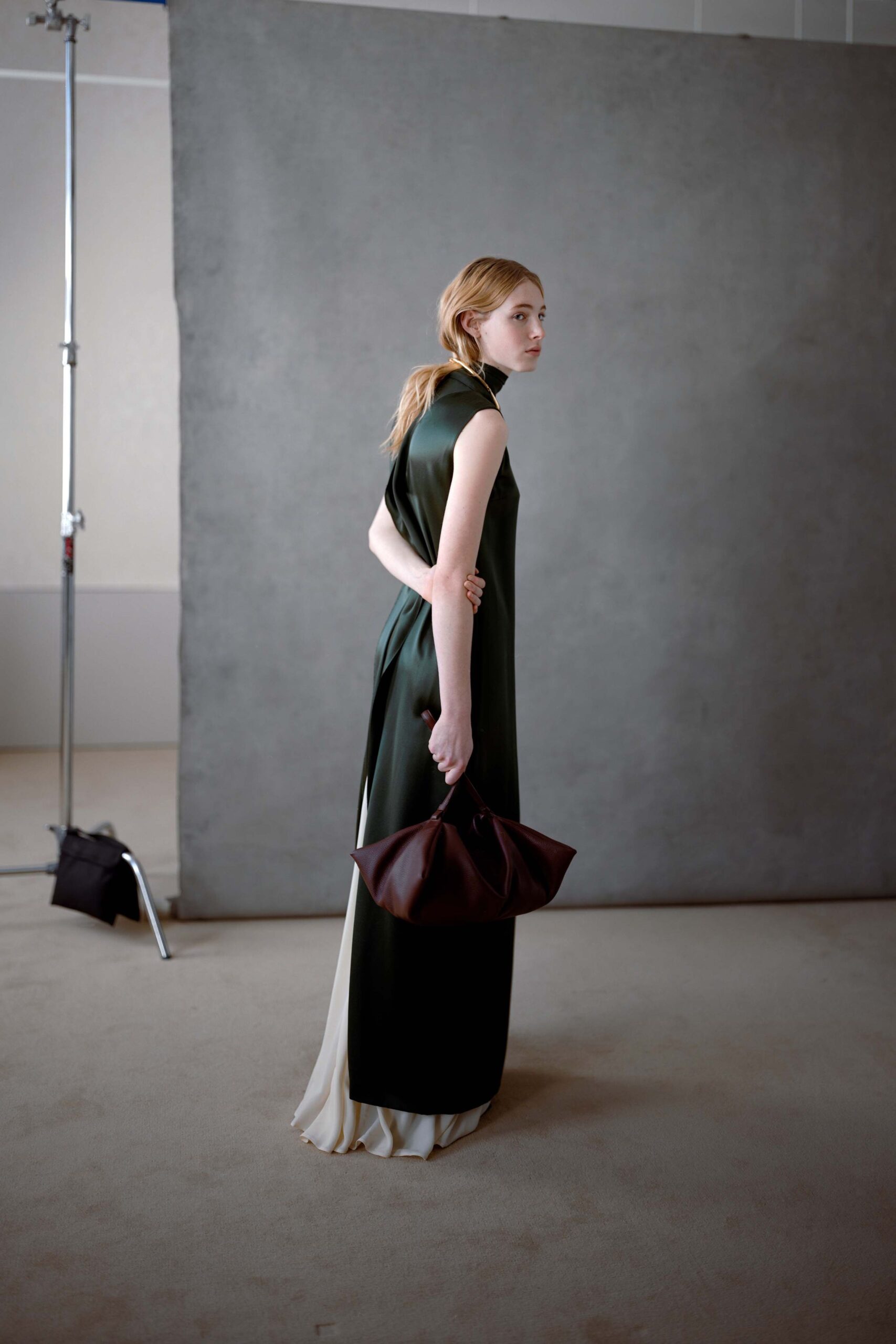 green silk sleeveless maxi dress with brown bag