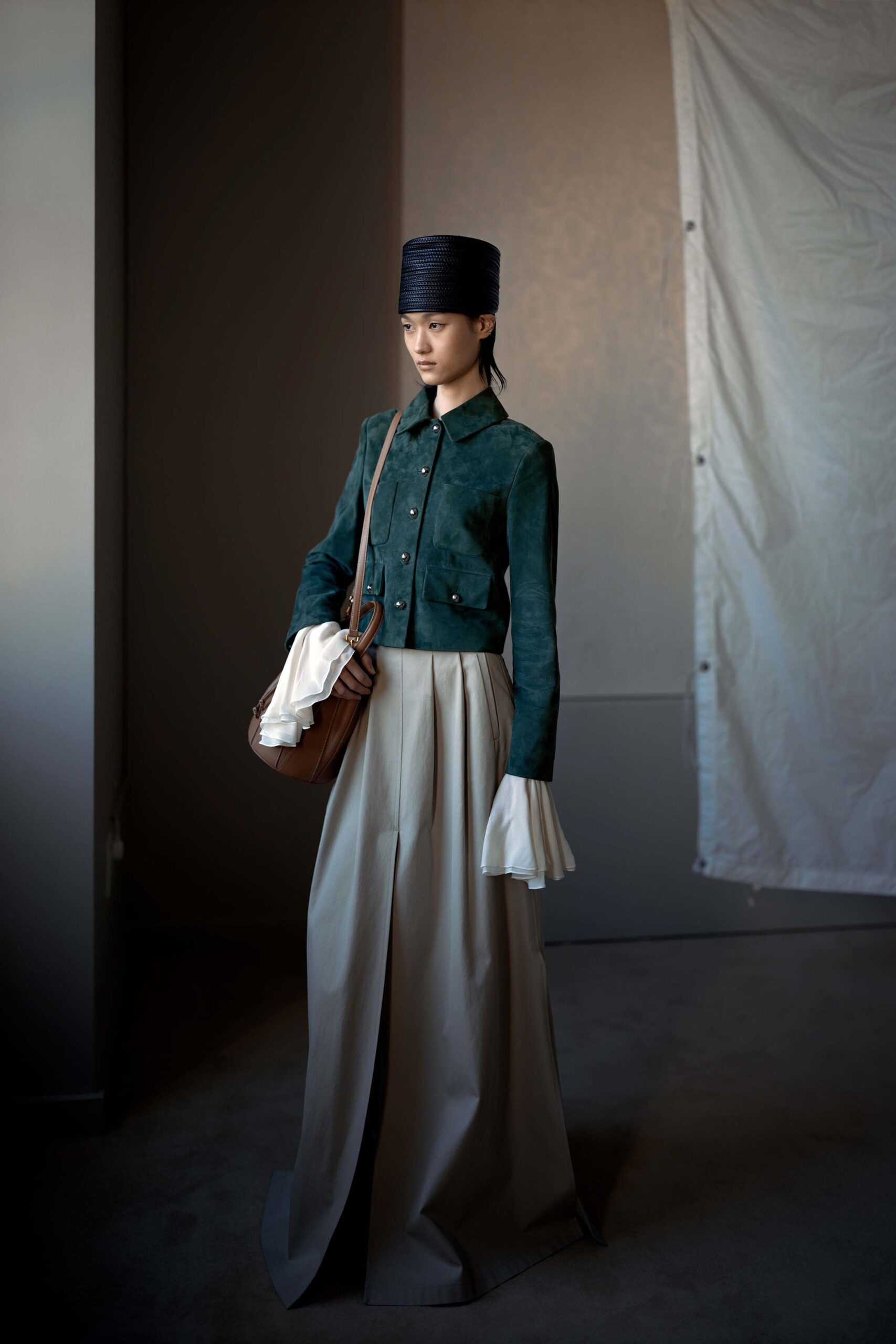 green suede jacket beige pleated skirt