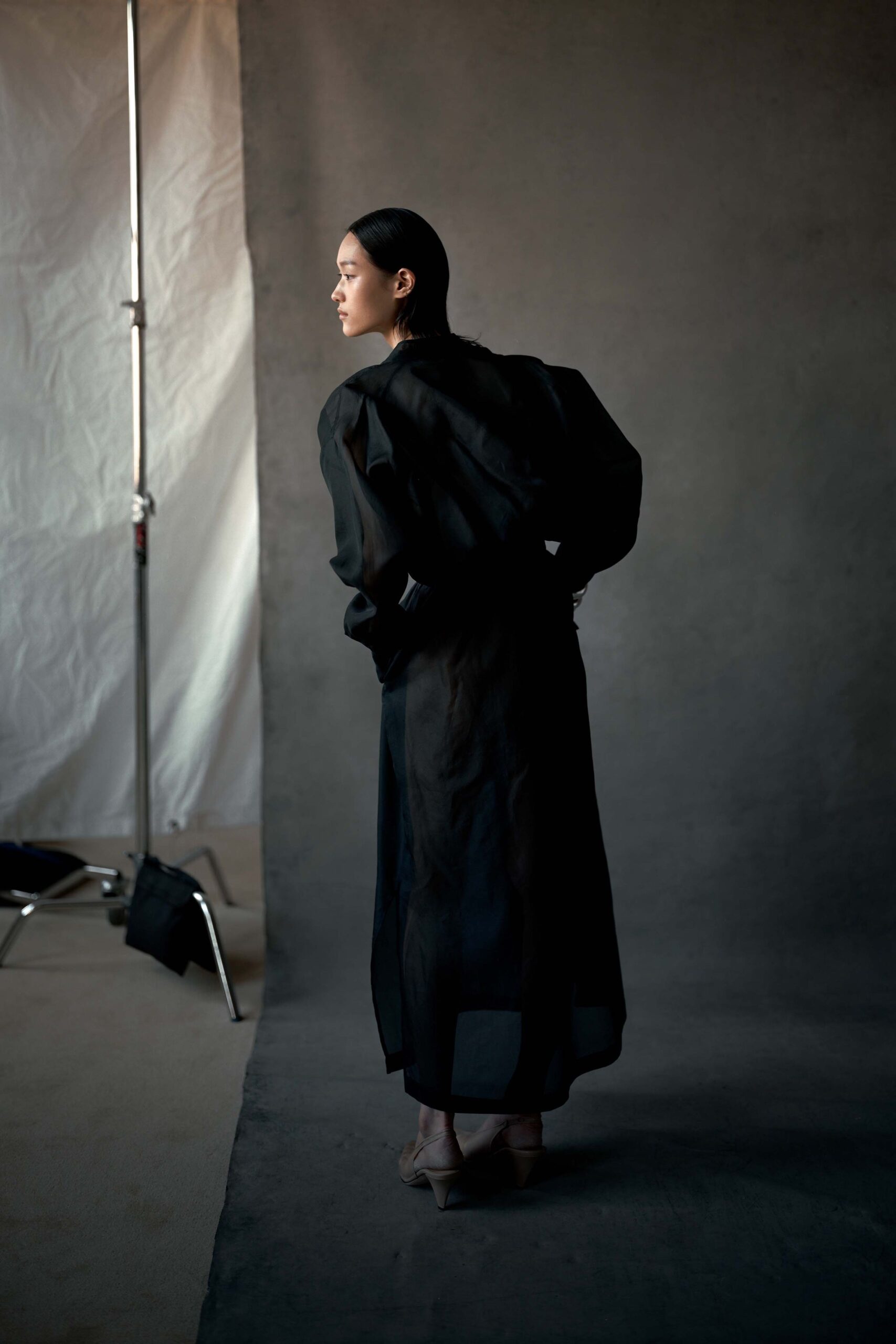black sheer long coat with beige shoes