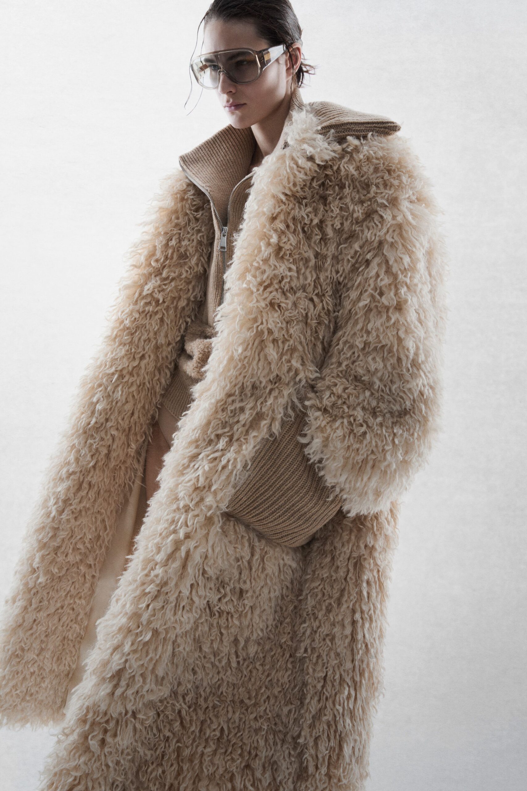 beige faux-fur coat with sweater