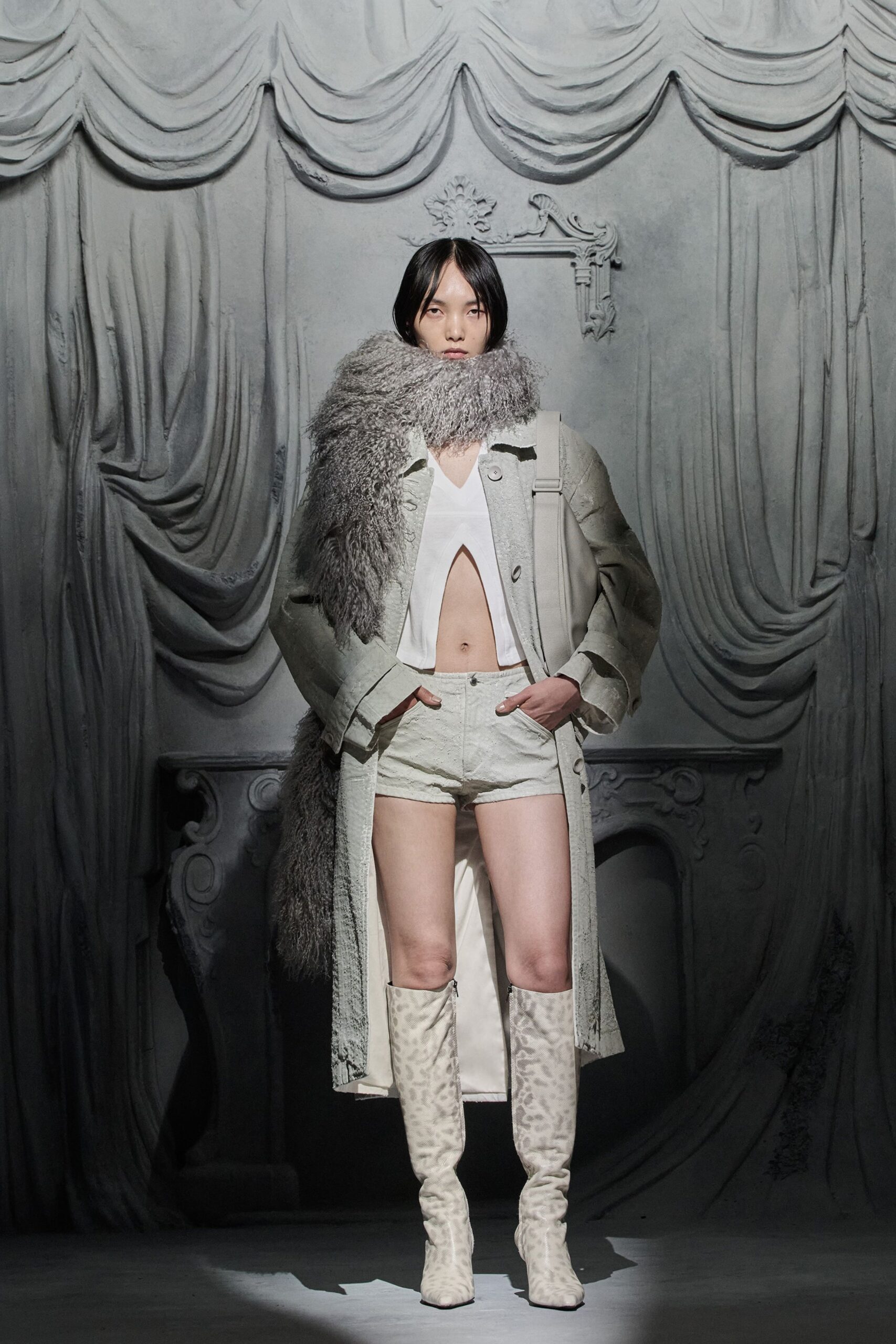 gray coat white top gray shorts
