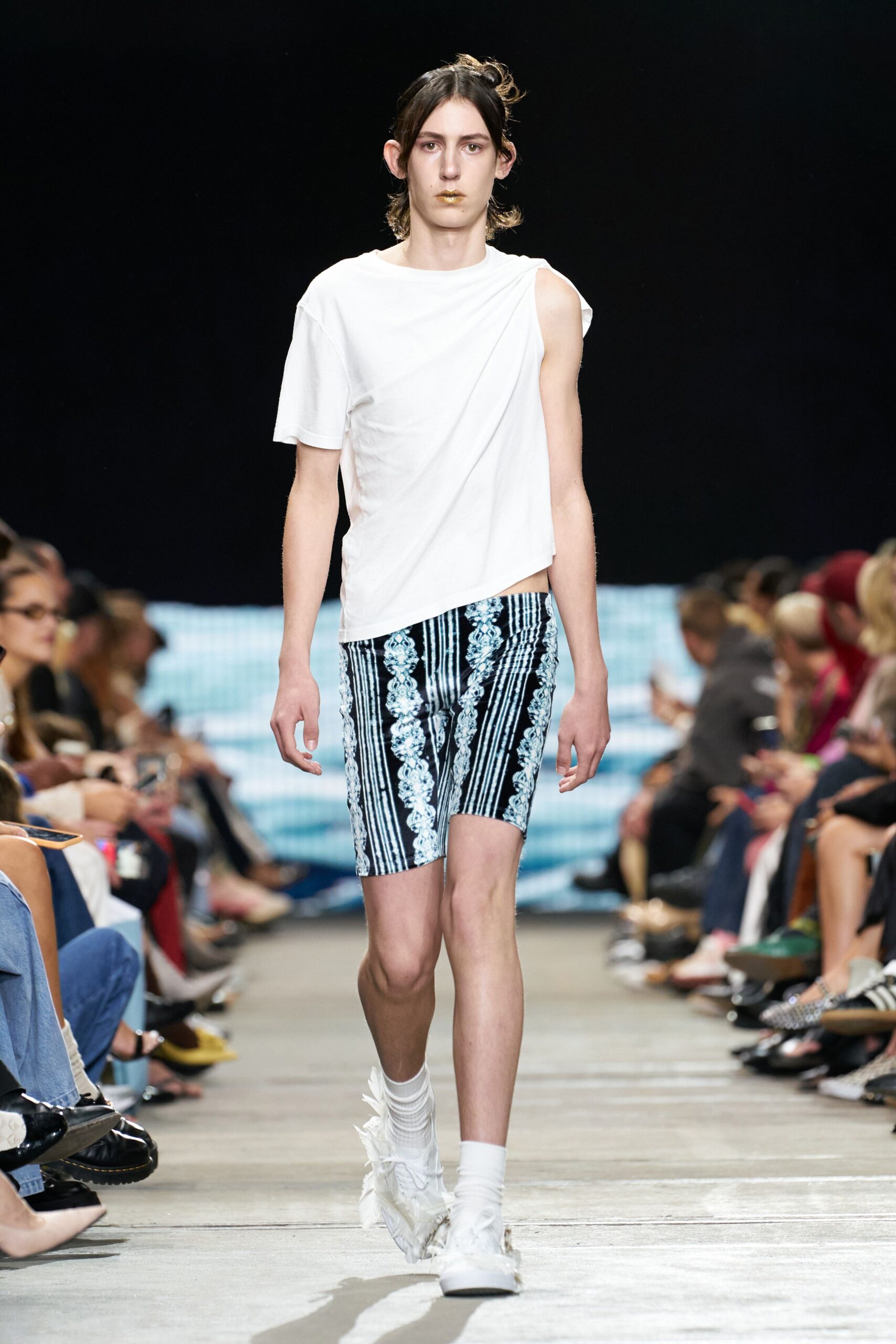 white asymmetric t-shirt with black striped shorts