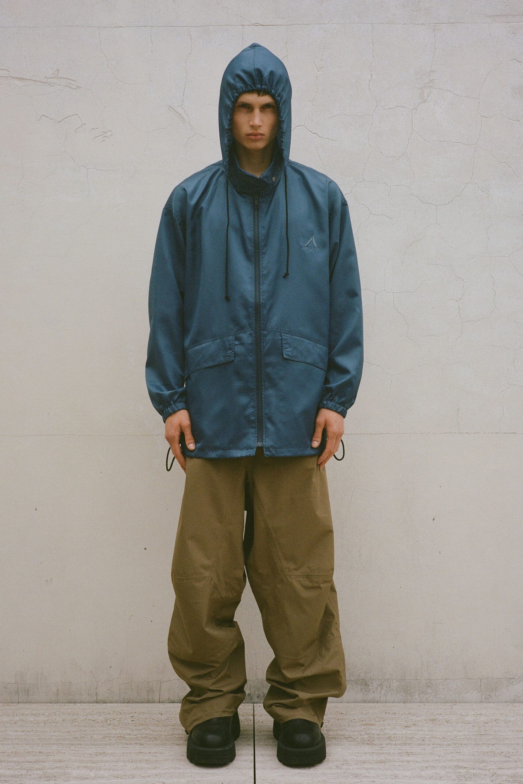 blue hooded jacket beige pants