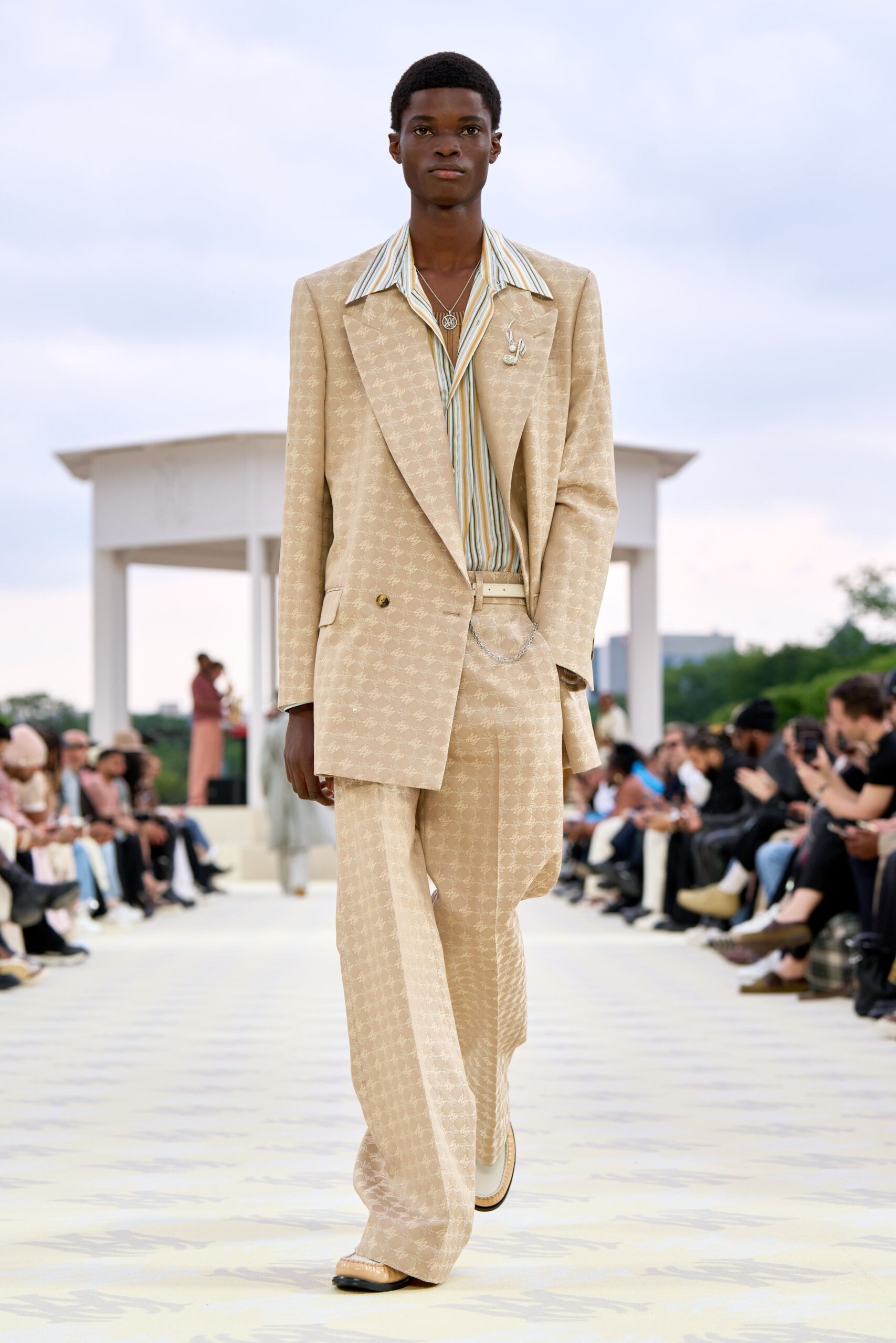 beige tailored suit with striped shirt