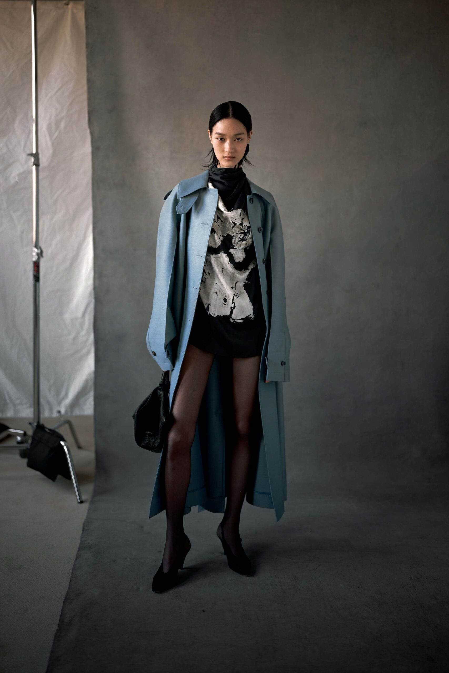blue coat black top and shorts