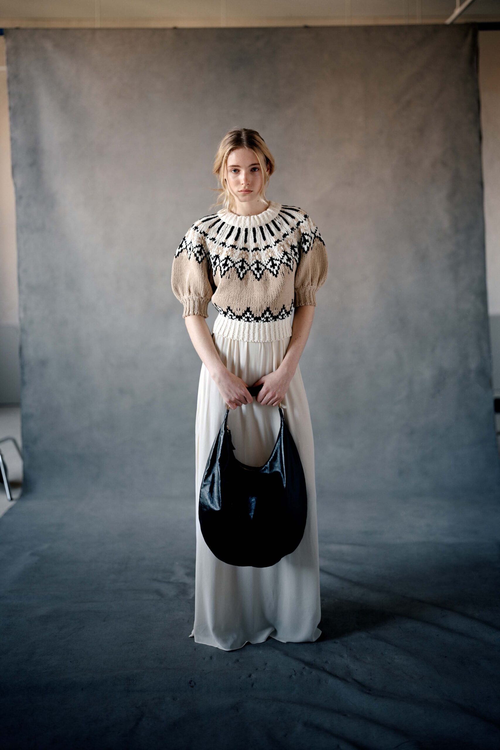 beige embroidered top with white skirt