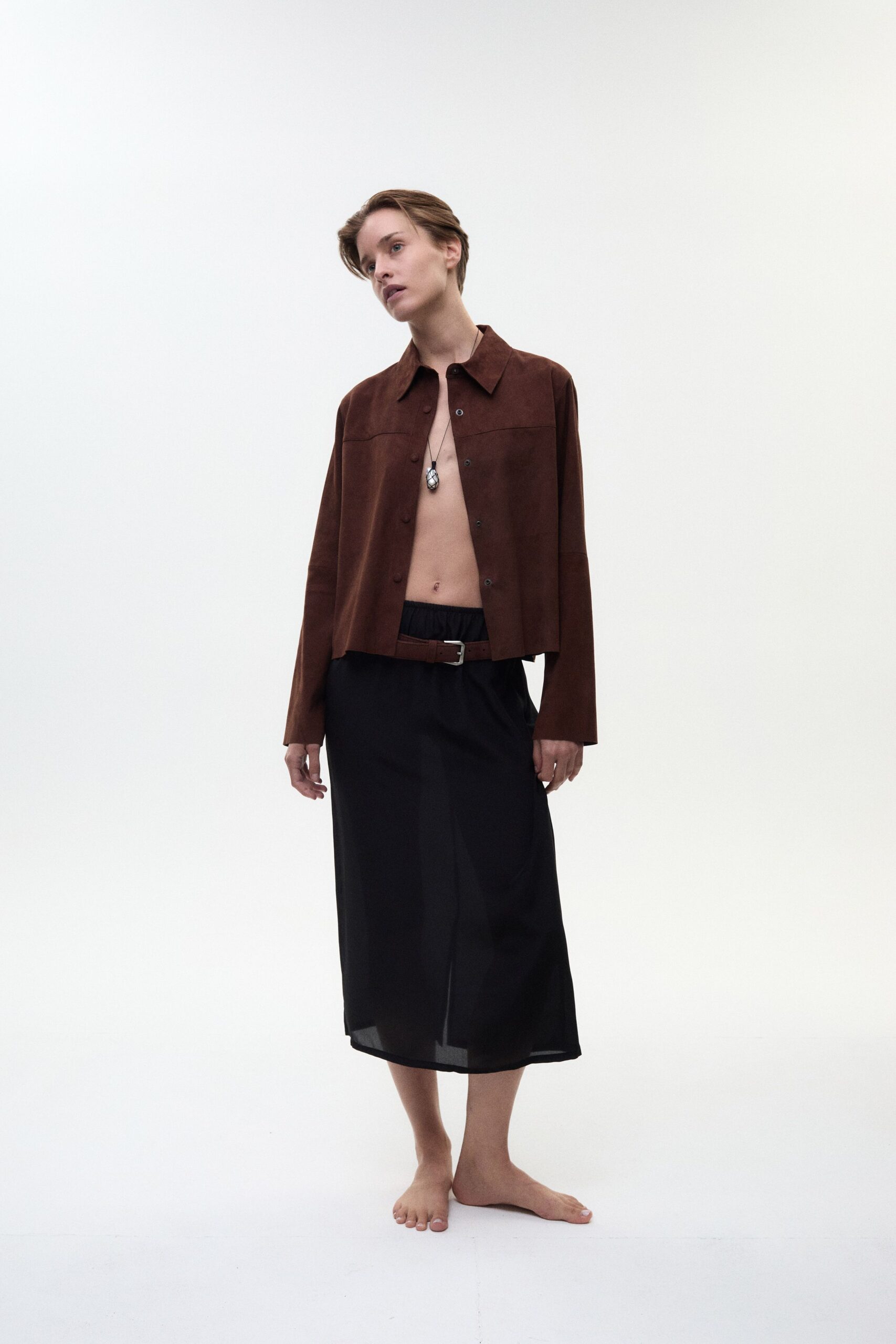 brown suede jacket and black midi skirt
