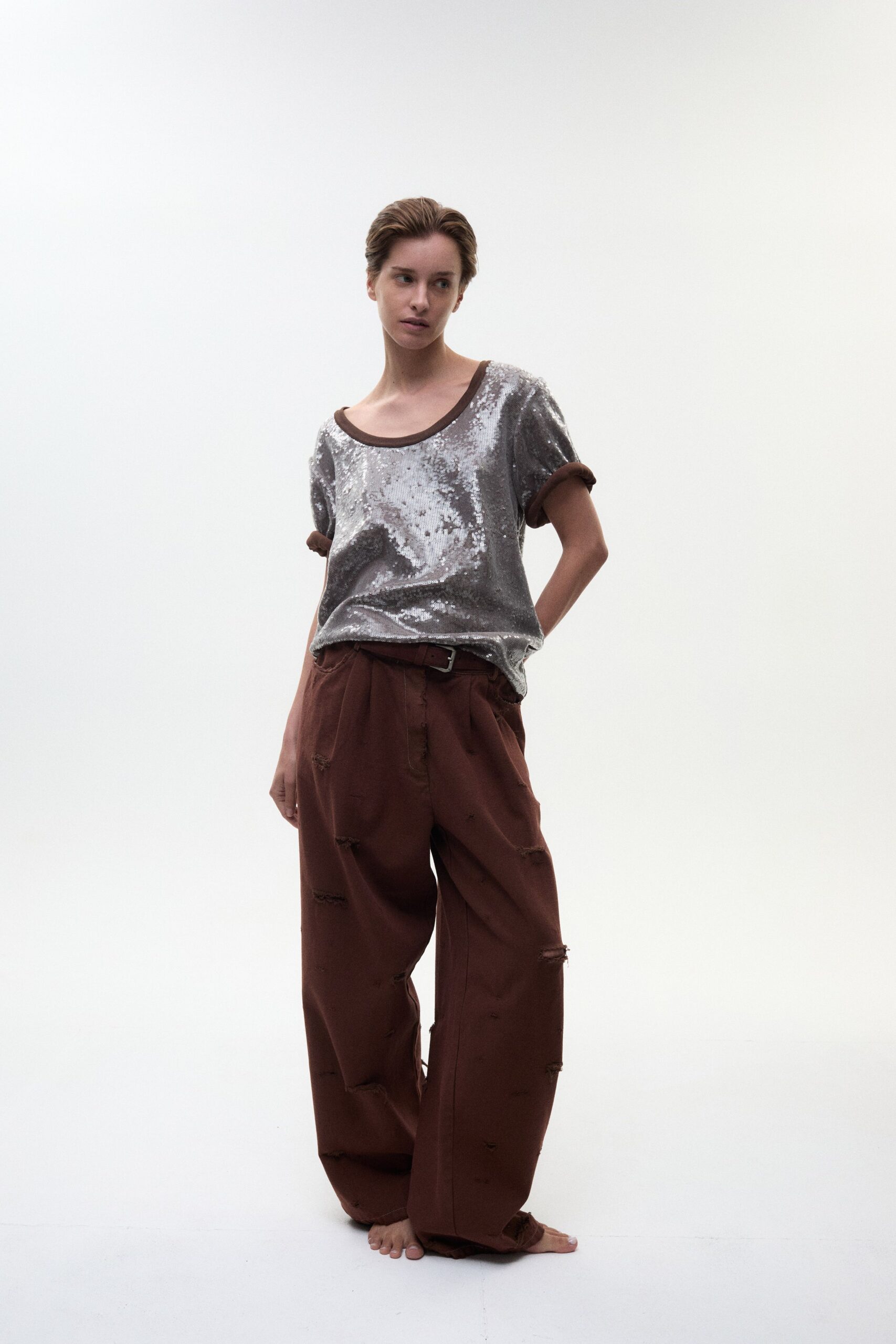 shiny silver relaxed top with brown pants