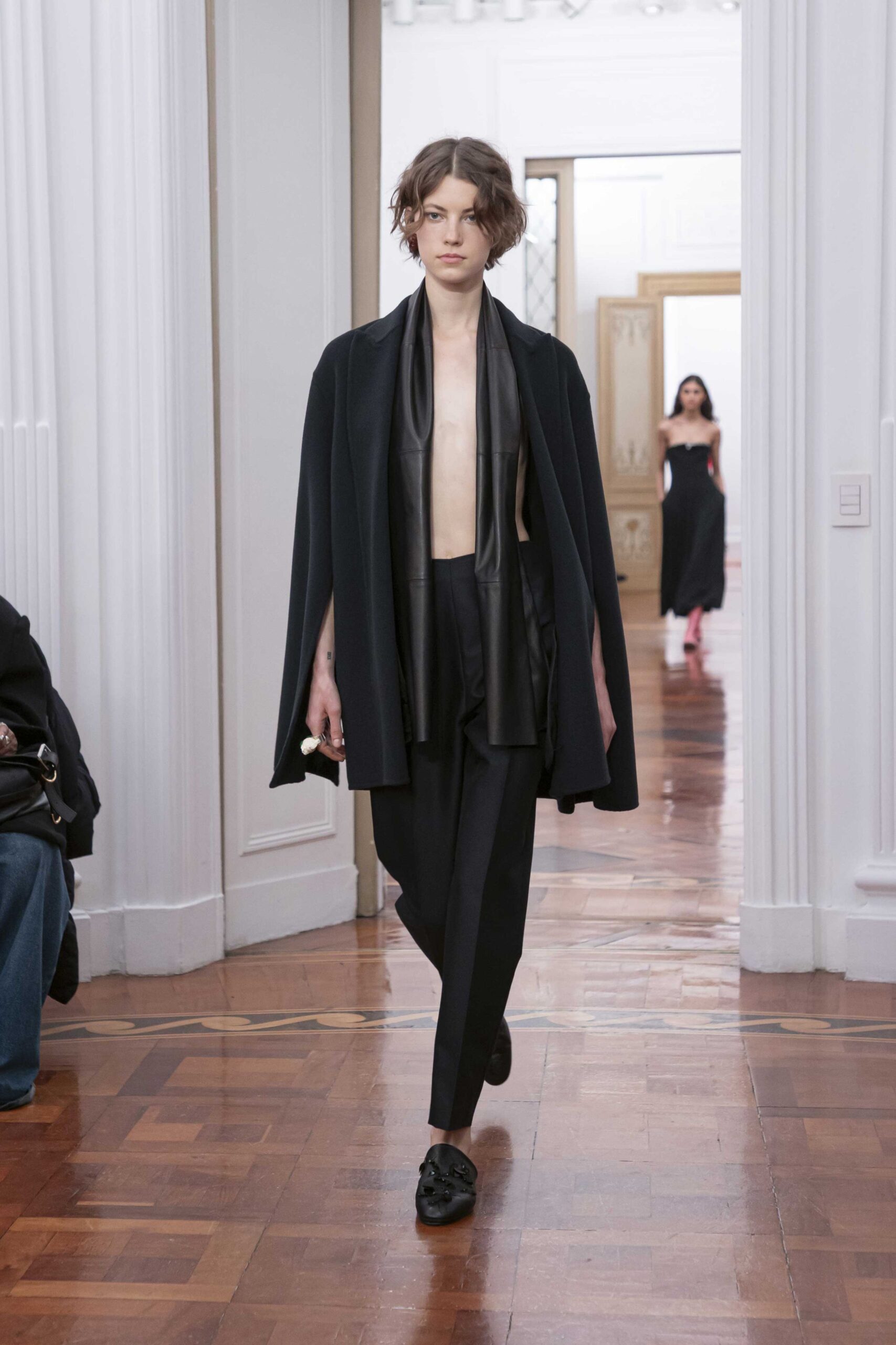 black wool cape and tailored pants