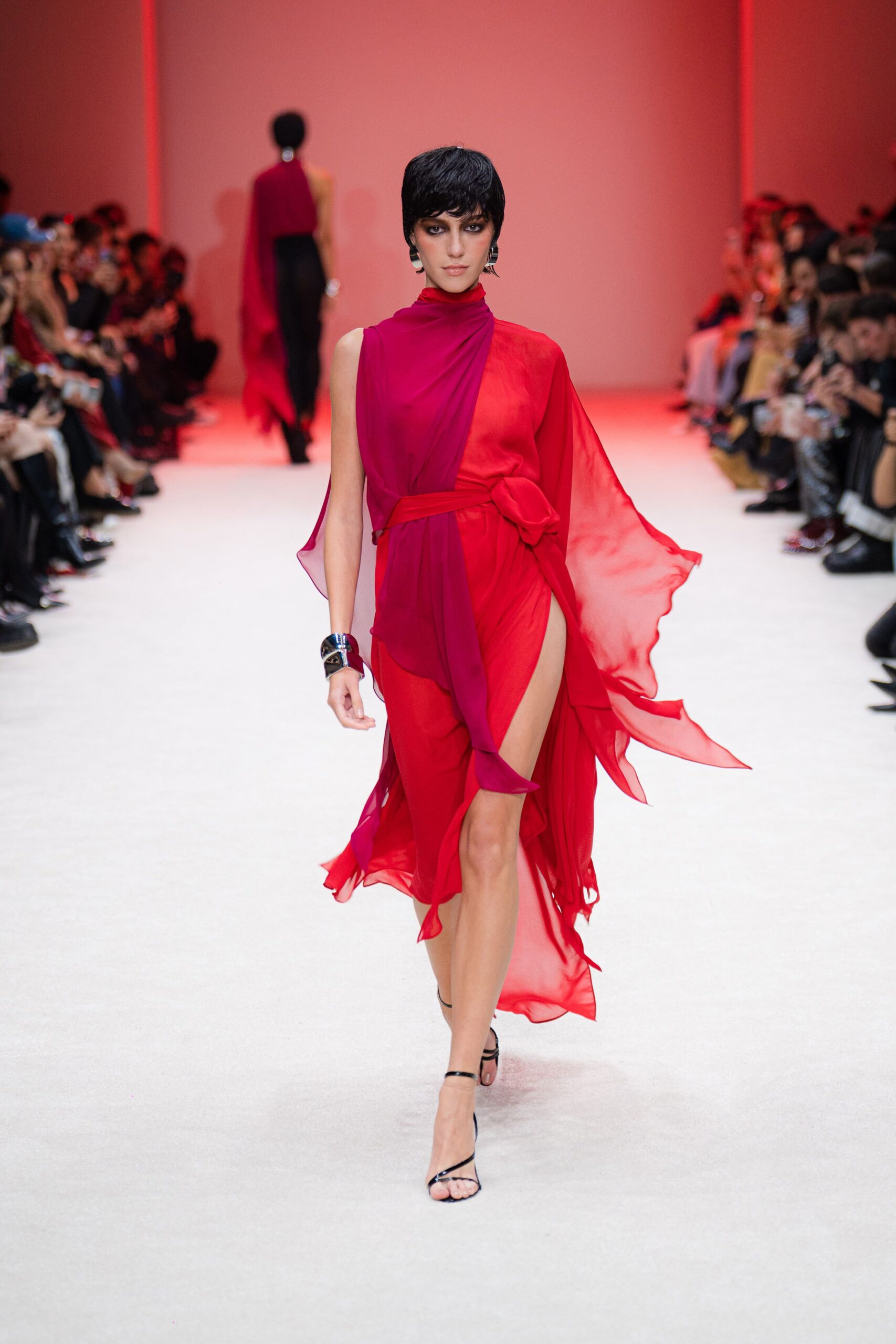 red silk sleeveless high-neck fitted draped flowing gown