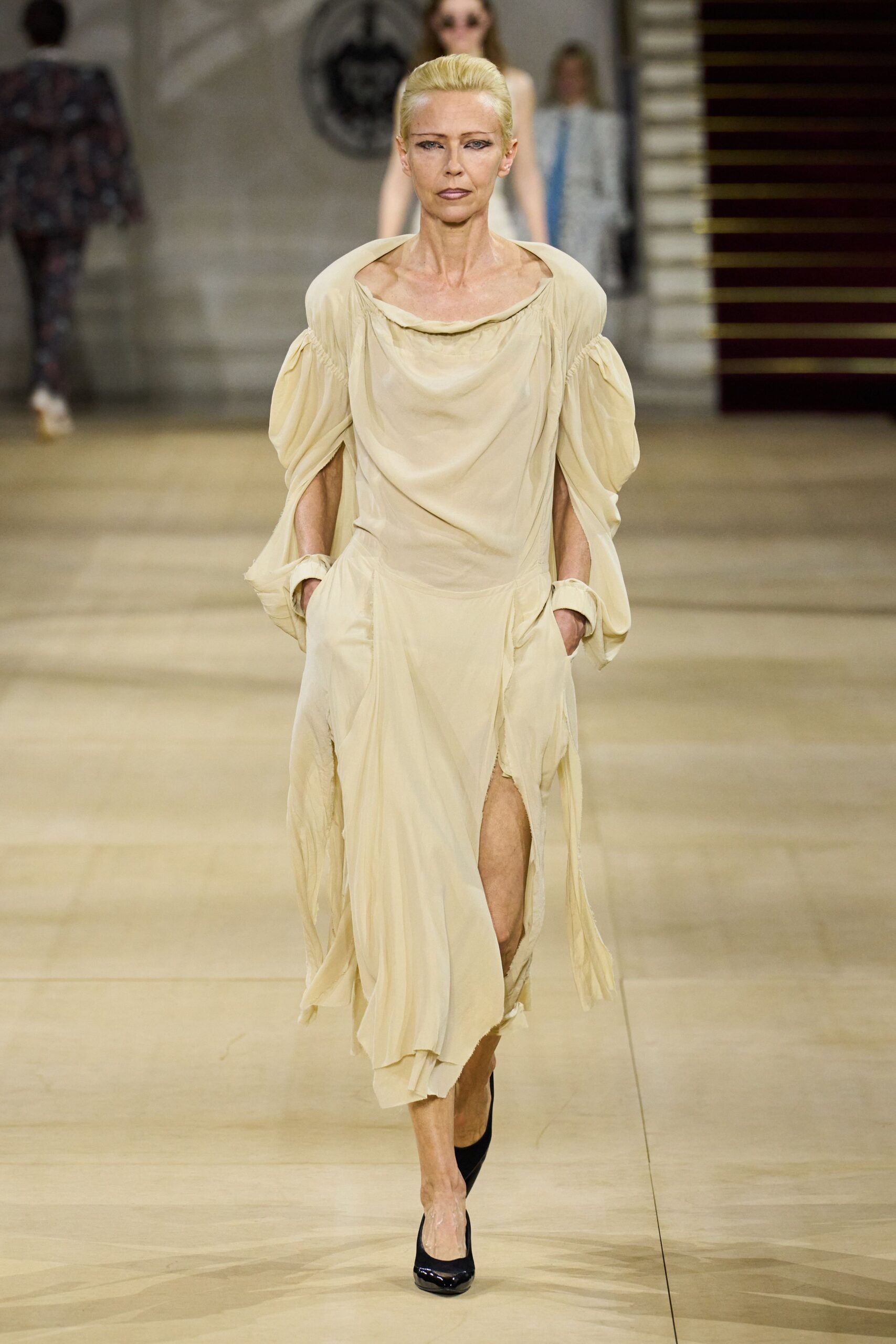beige relaxed off-shoulder dress with black shoes