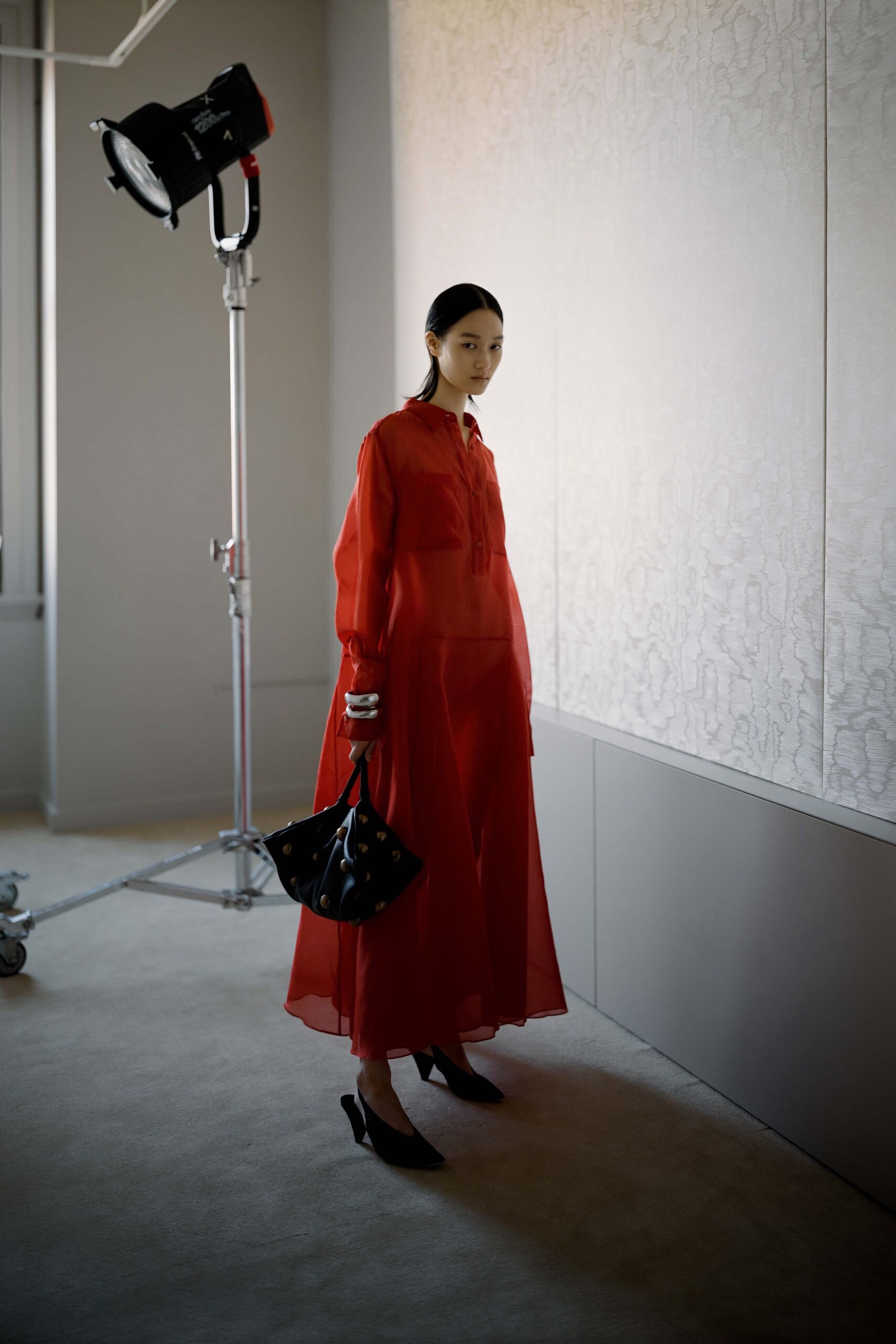 red sheer maxi dress with black accessories